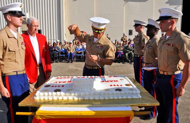 Lt. Col. James Wellons, Marine Fighter Attack Training Squadron 501commander, cuts the cake during the traditional cake-cutting ceremony at the squadron’s United States Marine Corps’ 235th birthday celebration Nov. 10.  Standing by to receive cake at right, are Master Gunnery Sgt. Stanley Kennedy, VFMAT-501 aircraft maintenance chief, the squadron’s oldest Marine; and Cpl. Jeff Brown, VMFAT-501 aviation structural mechanic, the youngest Marine.  At left is the guest of honor, Col. Carl Bergstrom, USMC (ret.), a Bronze Star recipient.  (U.S. Air Force photo/Kevin Gaddie) 
