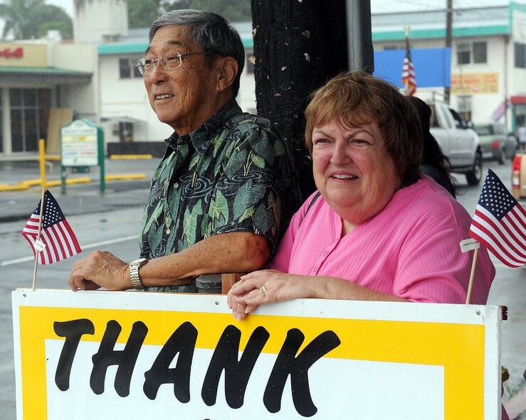 A couple stands holding up a sign during the 2010 Big Island Veterans Day Parade in Hilo, Hawaii, Nov. 6, 2010. The sign thanks veterans for their efforts defending their country. (U.S. Air Force photo/Tech. Sgt. Jerome S. Tayborn)