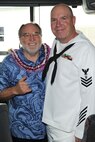 Newly elected Hawaii Governor Neil Abercrombie poses for a photo with Petty Officer 1st Class David Gentkowski from the Naval Pacific Fleet Band in Hilo, Hawaii, Nov. 6, 2010.  Governor Abercrombie and PO1 Gentkowski were in Hilo to participate in the 2010 Big Island Veterans Day Parade there. City officials invited the National Security Agency/Central Security Service Joint Service Color Guard and the Naval Pacific Fleet Band to participate in the parade that day. (U.S. Air Force photo/Tech. Sgt. Jerome S. Tayborn)