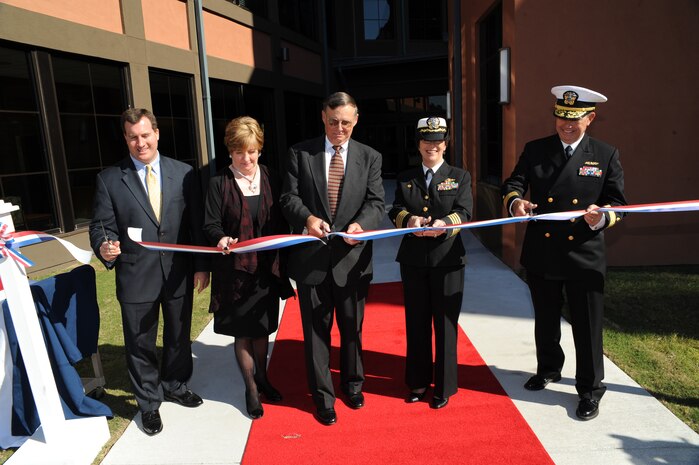 From left to right, Gregg Becker, Carolyn Adams, Navy Cmdr. John Feder, Navy Capt. Paula McClure and Navy Rear Adm. Alton Stocks cut the ribbon during the grand opening of the new Captain John G. Feder Joint Ambulatory Care Clinic Nov. 10, 2010, on Joint Base Charleston-Weapons Station, S.C. The new clinic is one of only a few joint facilities in existence and the only facility with the its unique resource sharing framework. Services provided at the new facility include Primary Care, Ob/GYN, Physical Therapy, General Surgery, Aviation/Undersea Medicine, Behavioral Health, Preventive Medicine, Occupational Health, MRI, Cardiology, Audiology, Orthopedics, Optometry/Ophthalmology, Wellness, Internal Medicine, Radiology, Libratory Services, Pediatrics and Pharmacy. (U.S. Air Force photo/James M. Bowman)(Released)