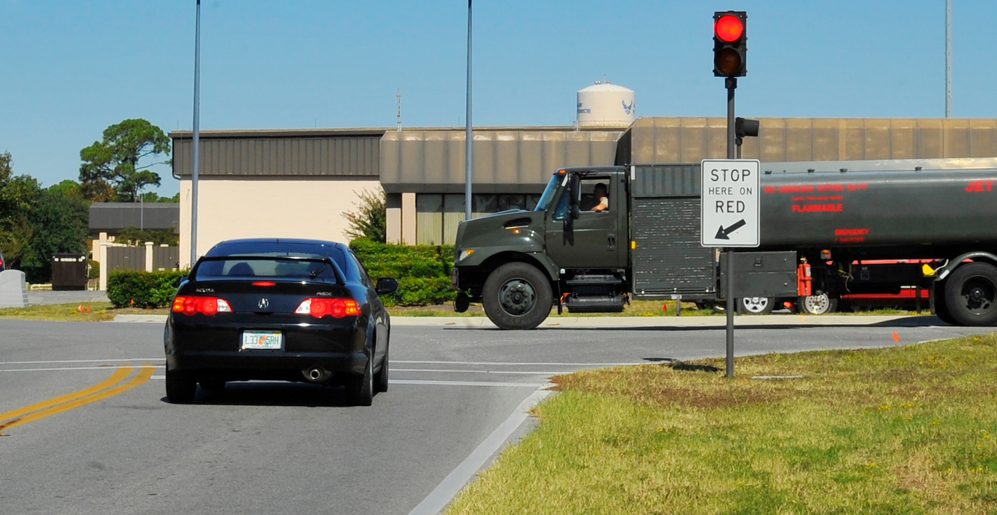 A driver stops at the traffic light by the Fuels Management building at the intersection of Tully and McClean Street. Drivers should be extra vigilant in this area because of the frequent passing of the 1st Special Operations Logistic Readiness Squadron fuel trucks. (Air Force photo by Senior Airman Sheila deVera) (RELEASED)