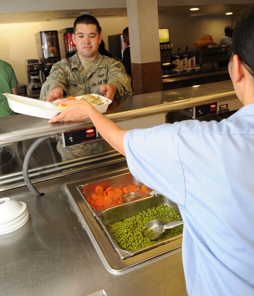 Airman 1st Class Shaun Evans, 2nd Operational Support Squadron, recieves his food at the Red River Dining Facility on Barksdale Air Force Base, La., Nov. 10. Airmen have the option of either dining in or taking their food to-go as long as they are meal-cards holders. (U.S. Air Force photo/Airman 1st Class Sean Martin)(Released)