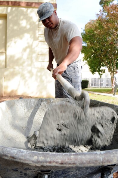 Staff Sgt. John Candanedo, 2nd Civil Engineer Squadron, structural engineer, stirs mason mix at Barksdale Air Force Base, La., Nov 9. The mason mix will be used to raise a manhole eliminate groundwater from running into it. (U.S. Air Force photo/Senior Airman Brittany Y. Bateman)(RELEASED)