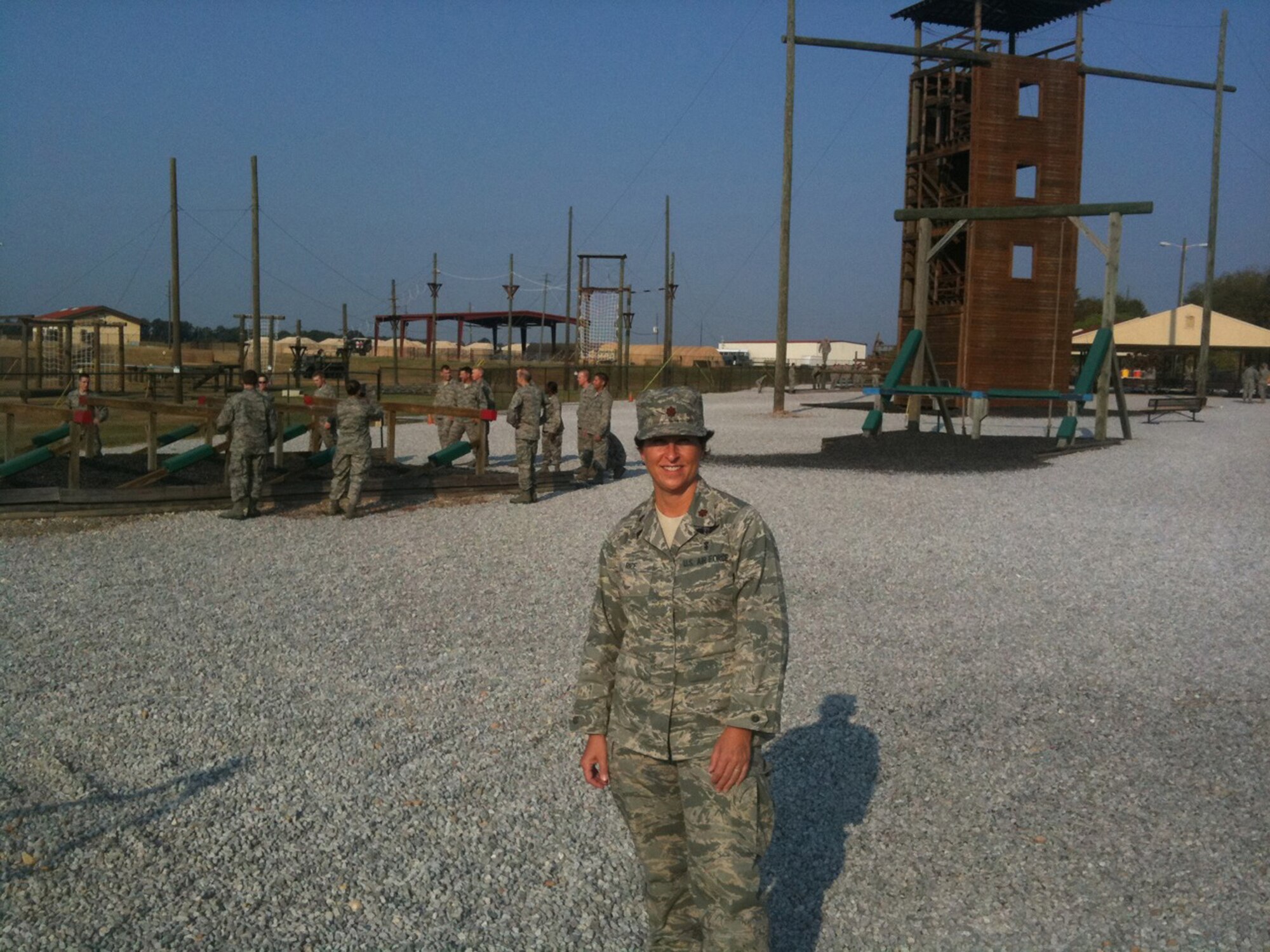 WRIGHT-PATTERSON AIR FORCE BASE, Ohio - Maj. Dawn Rice, 445th Aeromedical Evacuation Squadron, stands in front of an obstacle training course at Maxwell Air Force Base, Ala.  Major Rice became a certified commissioned officer training instructor this summer. (Courtesy photo)