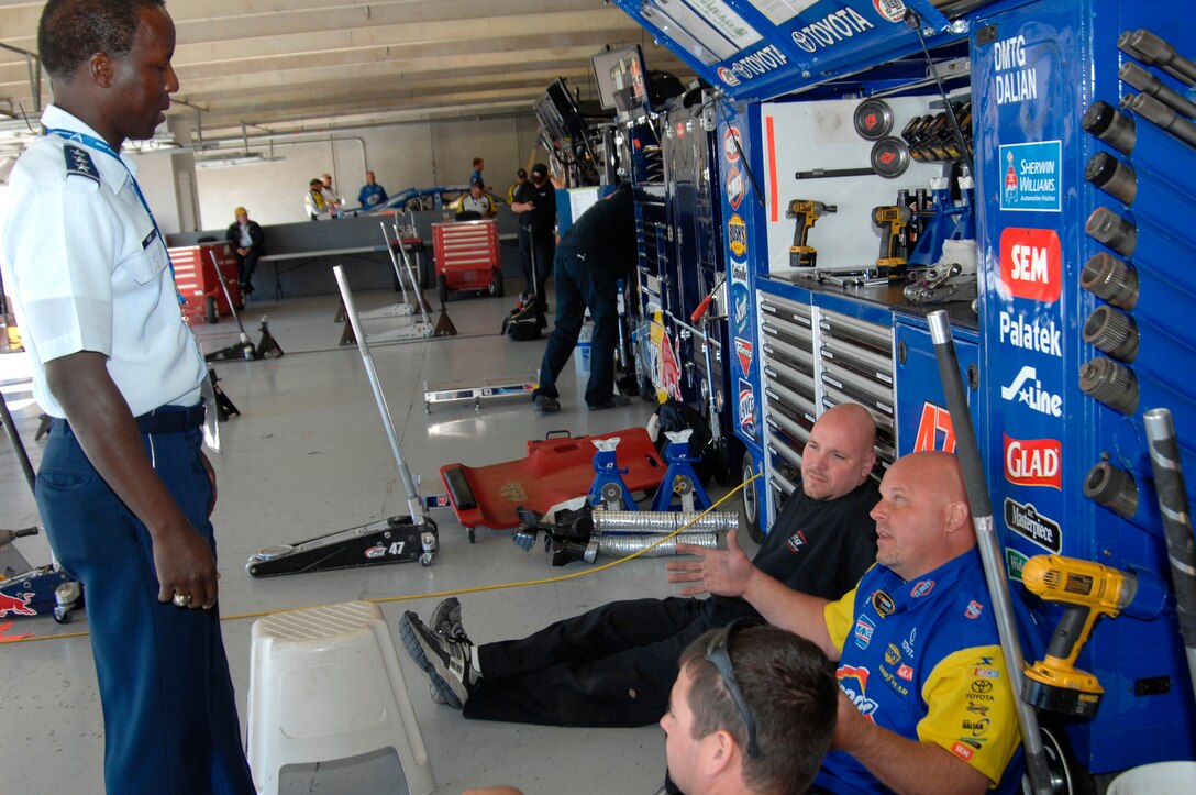 Lt. Gen. Edward A. Rice Jr., incoming commander of Air Education and Training Command, speaks with pit crew members at Texas Motor Speedway Nov. 7, 2010, before the NASCAR Sprint Cup Series race. The general, who has been confirmed for his fourth star, conducted a swearing-in ceremony for Delayed Enlistment Program members, and met members of the Air Force's No. 19 NASCAR team. (U.S. Air Force photo/Steven McCray)