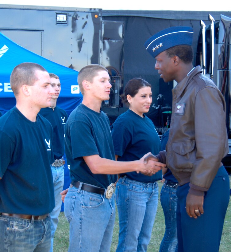 Lt. Gen. Edward A. Rice Jr., incoming commander of Air Education and Training Command, greets Delayed Enlistment Program members at Texas Motor Speedway Nov. 7, 2010, before the NASCAR Sprint Cup Series race. The general, who has been confirmed for his fourth star, conducted the DEP swearing-in ceremony in front of thousands of NASCAR fans before the start of the race. (U.S. Air Force photo/Steven McCray)