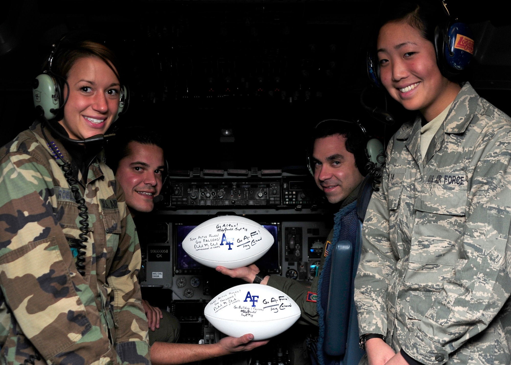 ALTUS AIR FORCE BASE, Okla. -- Cadets from the United States Air Force Academy present game footballs from the Nov. 6 Army-Air Force football game to the Altus AFB pilots that transported them to the game. Air Force beat Army, and took control of the Commander-in-Chief's trophy. (U.S. Air Force photo by Airman 1st Class Ross Whitley / Released 97th Air Mobility Wing Public Affairs)