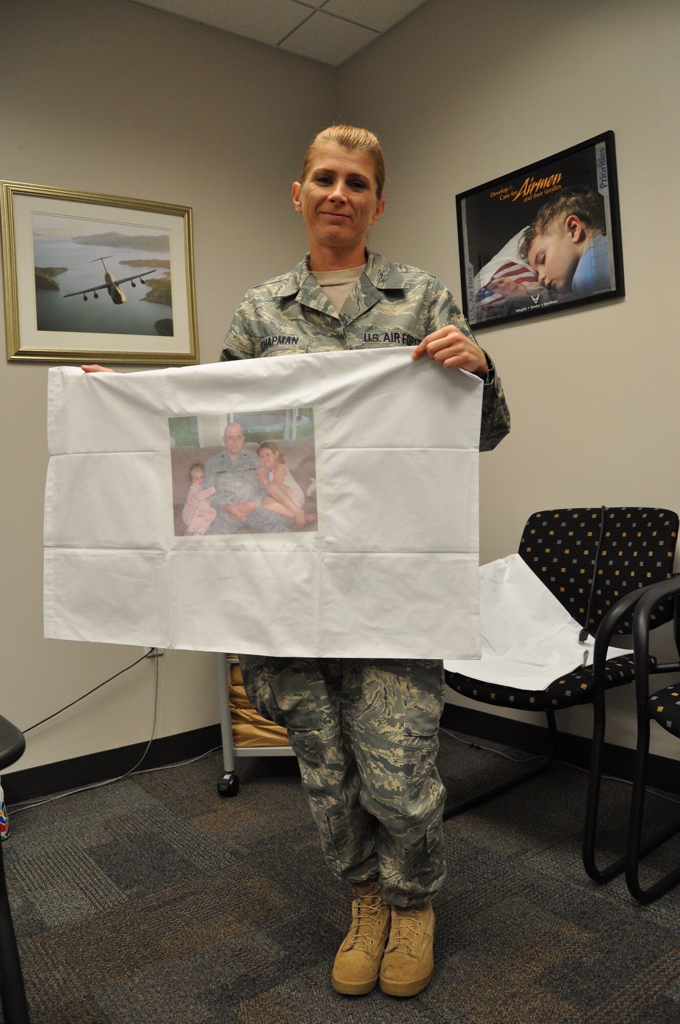 WRIGHT-PATTERSON AIR FORCE BASE, Ohio - Tech. Sgt. Heather Chapman, 445th Airman and Family Readiness office, holds a finished pillow case displaying the photo of a deployed Airman. (U.S. Air Force photo/Staff Sgt. Amanda Duncan)