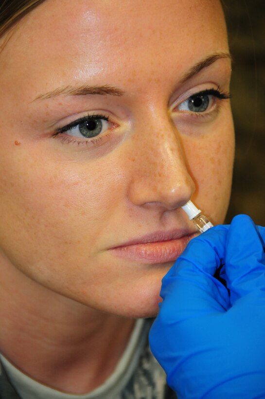 A Member of the 914th Airlift Wing gets a dose of the annual flu vaccine adminstred by Medical Techinicans from the 914th AeroMedical Patient Staging Squadron.  Depending on certain factors, reservists will either be administered the mist which is sprayed up the nose or the traditional injection in the arm (U.S. Air Force Reserve photo by Master Sgt. Peter Borys)
