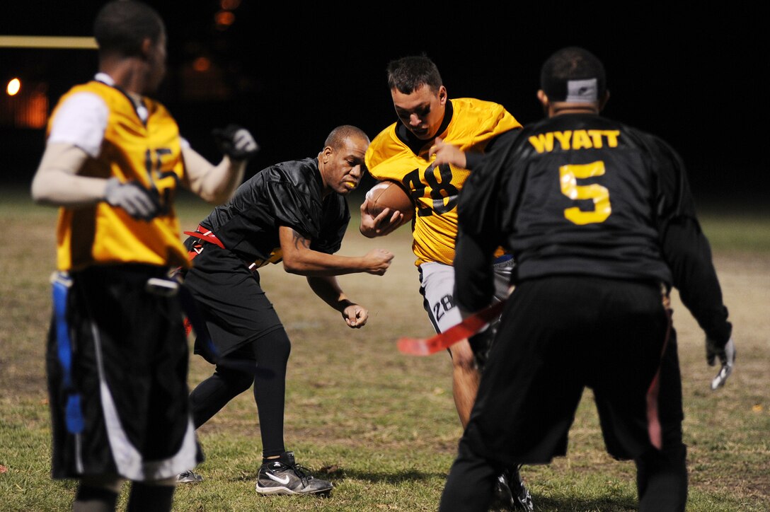 Senior Airman Daniel Mata, 11th Security Forces Squadron patrolman, maneuvers through defenders from the 779th Medical Group during the flag football championship game at Joint Base Andrews Nov. 8. The final score of the game was 20-6 with 11 SFS coming out on top. In addition, the 11 SFS team also placed first in a Washington Area Military Athletic Conference flag football tournament in Washington, D.C. Nov. 6. (U.S. Air Force photo/
Senior Airman Melissa V. Brownstein)  
