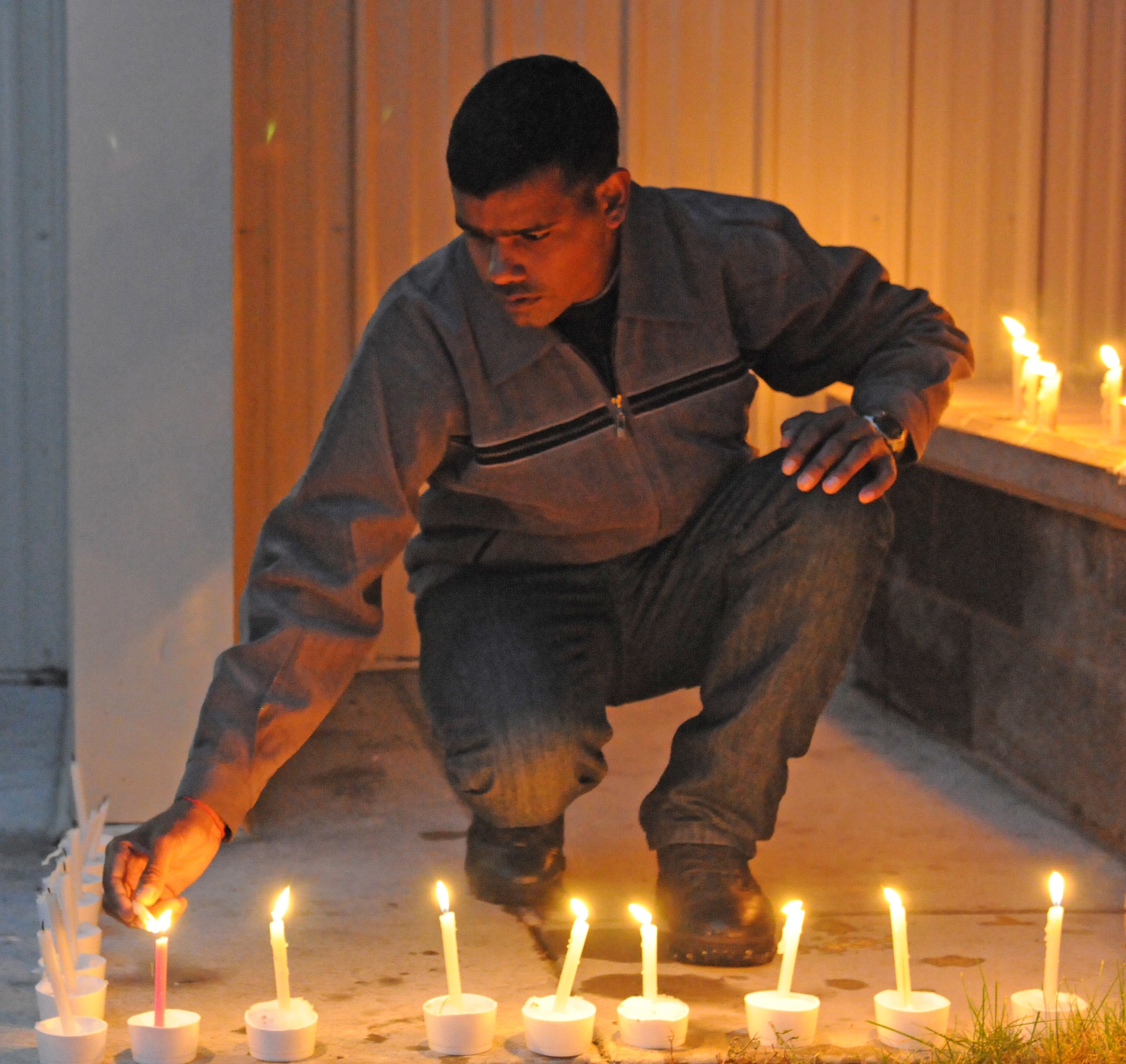 An Indian Army soldier lights candles, Nov. 5, during a Diwali festival celebrated with soldiers from the Indian Army and U.S. Army Alaska at the Wilderness Inn dining facility on Joint Base Elmendorf-Richardson. (U.S. Army photoSpc. Ashley Armstrong)