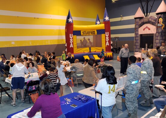 Team McConnell personnel and family members enjoy food and games during the annual Family Fun and Feast night held at the Youth Center on Nov. 9, 2010, at McConnell Air Force Base, Kan. The two-hour event provided hamburgers, hotdogs, drinks, snacks and activities for Team McConnell families. The event was hosted by the Airman and Family Readiness Center to showcase the various services offered throughout the base. (U.S. Air Force Photo/Airman 1st Class Andrea Salazar) 