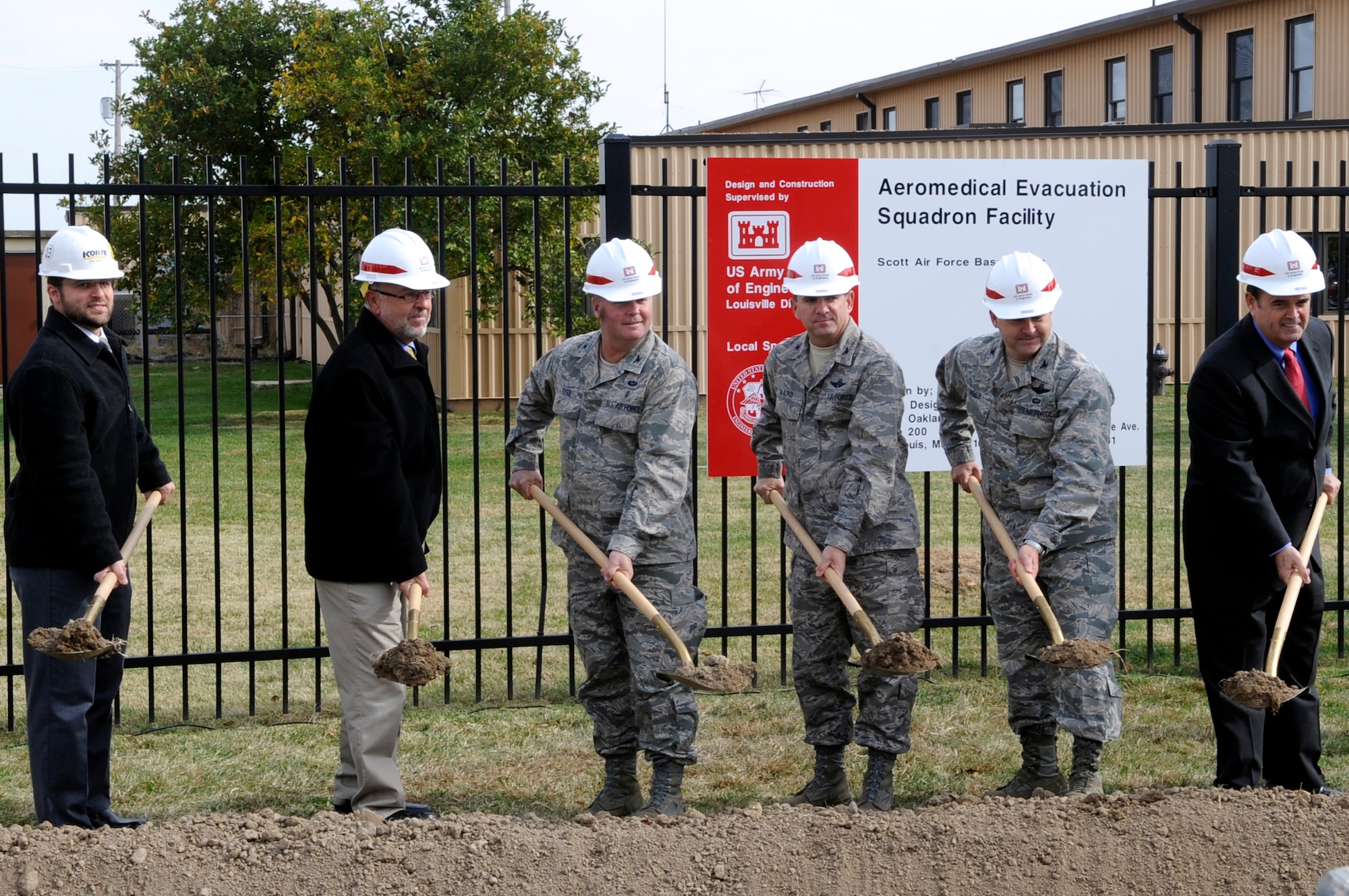 SCOTT AIR FORCE BASE, Ill. -- From left to right, Eric Tritsch, Quality Control for Charpie-Korte Joint Venture, David Mueller, U.S. Army Corps of Engineers resident engineer for Scott AFB, Col. William Tyra, 375th Aeromedical Evacuation Squadron commander, Col. Terry Ward, 375th Operations Group commander, Col. Kevin Webb, 375th Air Mobility Wing vice commander and the Honorable Jerry Costello, Illinois Congressman, shovel the first scoops of dirt at the groundbreaking ceremony for the Aeromedical Evacuation Complex Nov. 2 at Scott. (U.S. Air Force Photo by Senior Airman Andrew Davis)

