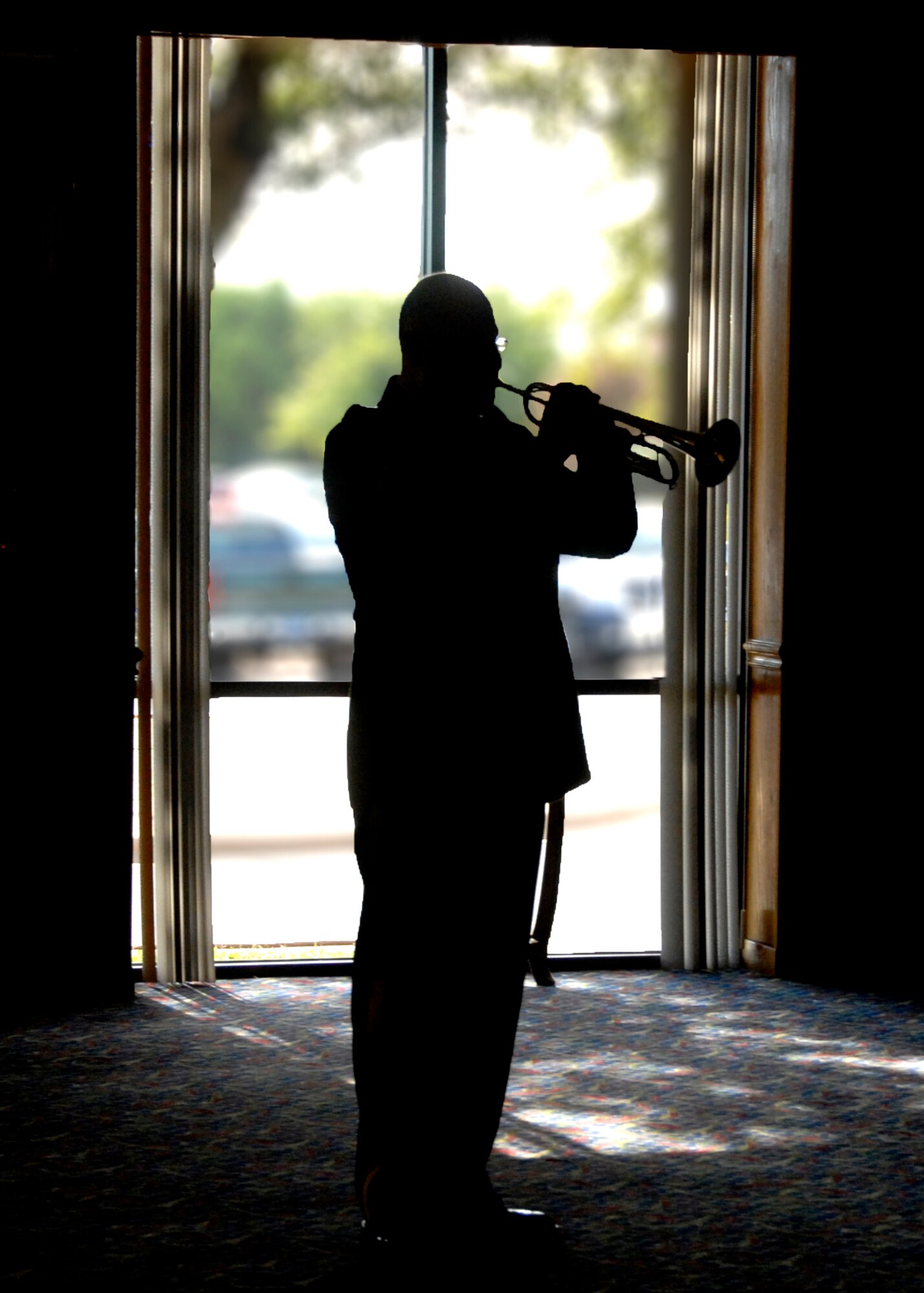 A lone trumpeter plays "Taps" Nov. 9 during Sheppard's annual Veteran's Day Luncheon at the Sheppard Club. Originally used to signal "lights out" for military encampments, the military began using "Taps" in the late 1800s for funerals and special recognition events. (U.S. Air Force photo/Mike Litteken)