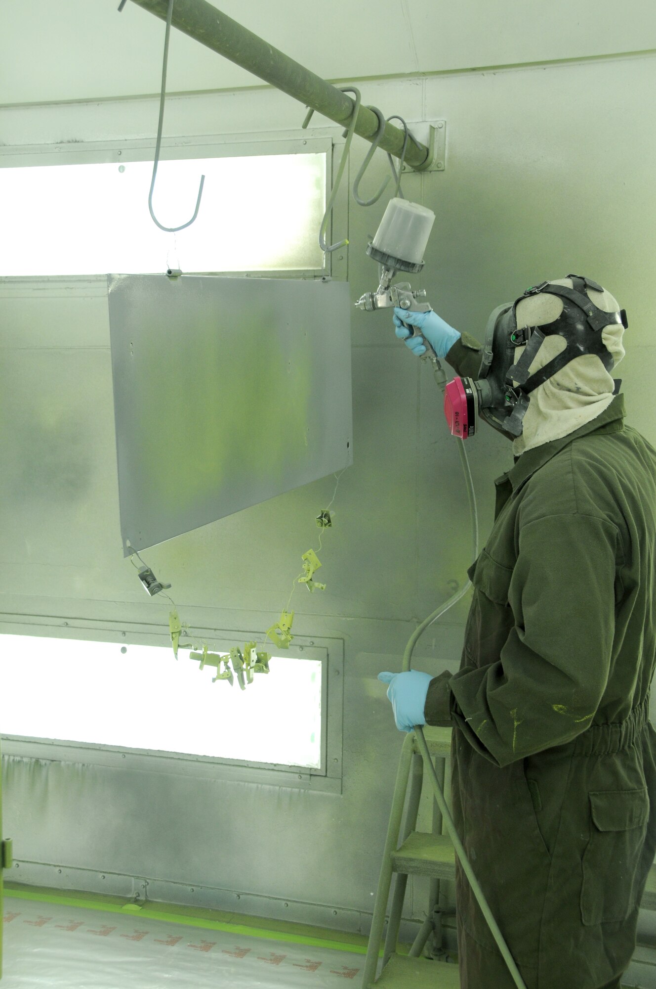 Staff Sergeant Chris Call, 173rd Fighter Wing Structural Maintenance shop, lays down a coat of grey paint on a disassembled piece of Aerospace Ground Equipment at Kingsley Field, Ore., October 28, 2010.  (U.S. Air Force photo by Senior Airman Bryan Nealy) Released 

