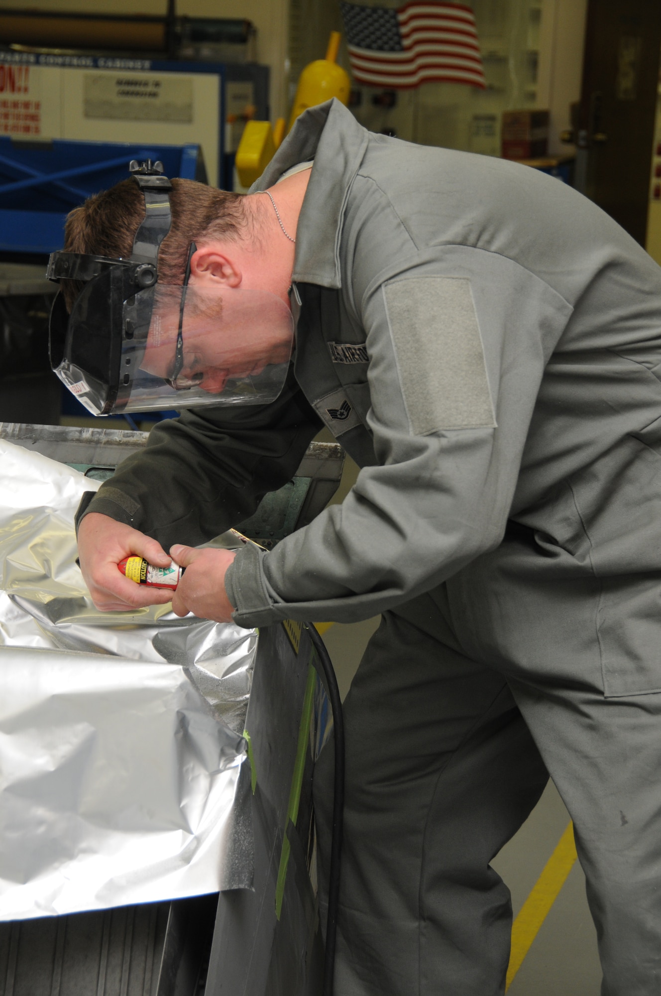 Staff Sergeant Paul Allen, 173rd Fighter Wing Structural Maintenance, grinds off excess metal from an F-15 part at Kingsley Field, Ore., October 28, 2010.  (U.S. Air Force photo by Senior Airman Bryan Nealy) Released 
