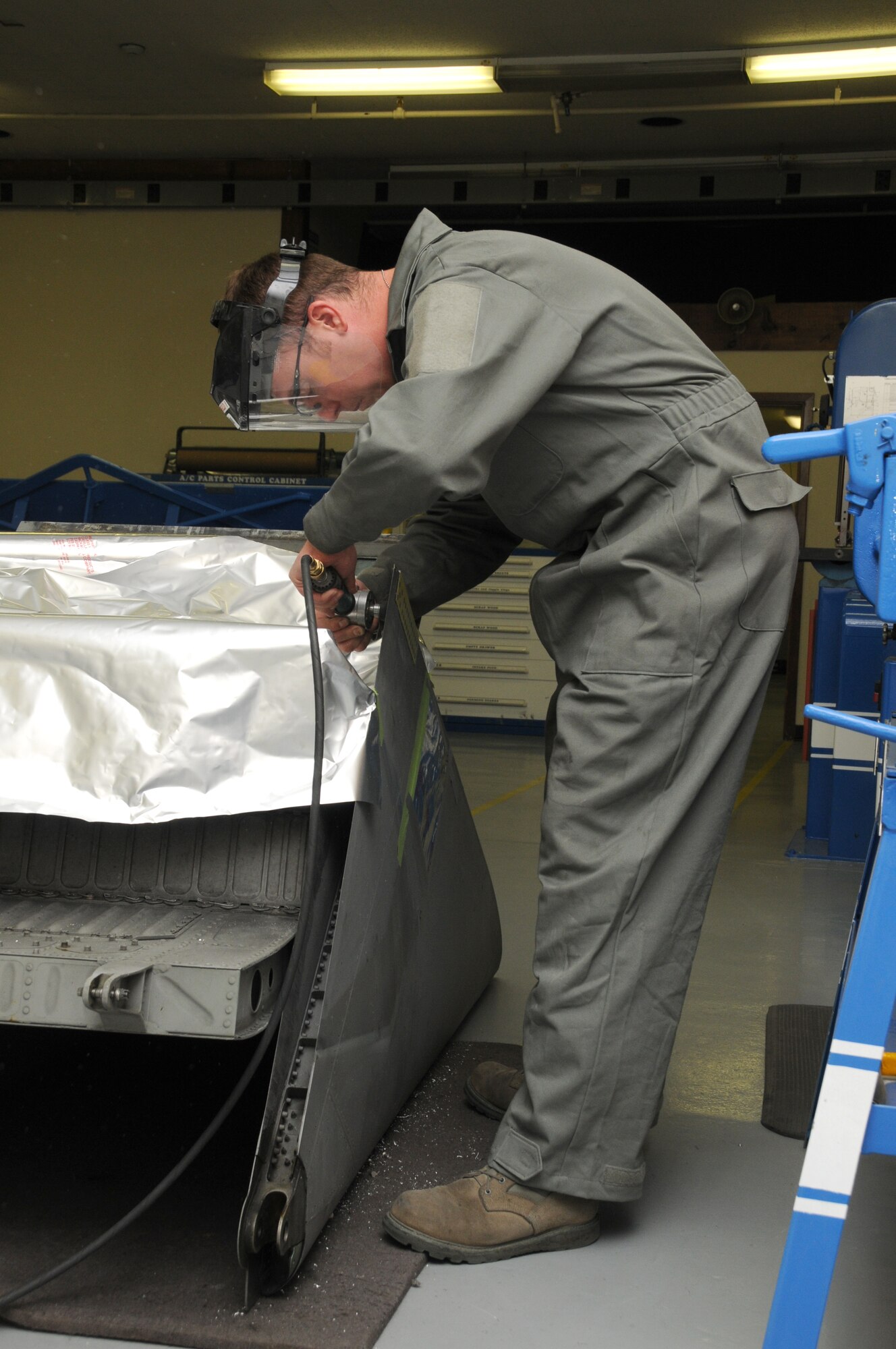 Staff Sergeant Paul Allen, 173rd Fighter Wing Structural Maintenance shop, grinds off excess metal from an F-15 part at Kingsley Field, Ore., October 28, 2010.  (U.S. Air Force photo by Senior Airman Bryan Nealy) Released 
