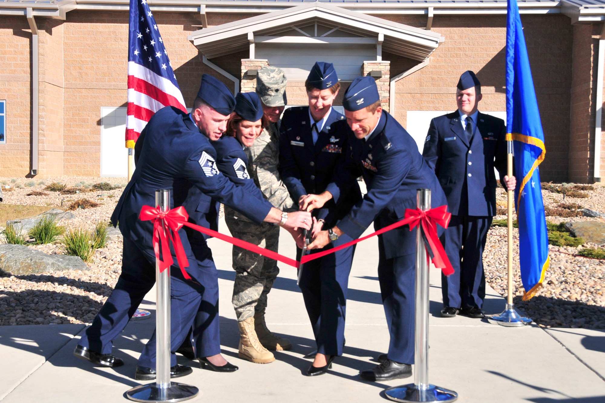 From left, Chief Master Sgts. Rocky Hart, Michelle Zayatz, Lt. Col David Schaefer, Cols. Karen Rizzuti and Gene Odom cut the ribbon of the 310th Mission Support Group Aero Medical Dental Flight Building on Nov. 7 at Buckley Air Force Base, Colo. The new facility will provide personnel, manpower and medical services to the Reservists of the 310th Space Wing. (Air Force photo by Tech. Sgt. Nick Ontiveros)