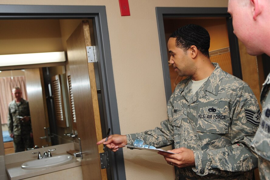 Tech. Sgt. Adolphus Sims, dorm manager, performs a dorm room introduction with Airman 1st Class Dustyn Wilson, 608th Air Operation Center, at Barksdale Air Force Base, La., Nov. 9. All airmen must complete this inspection to ensure all pre-existing discrepancies are accounted for before they are issued a mailbox. (U.S. Air Force photo/Senior Airman Joanna M. Kresge)