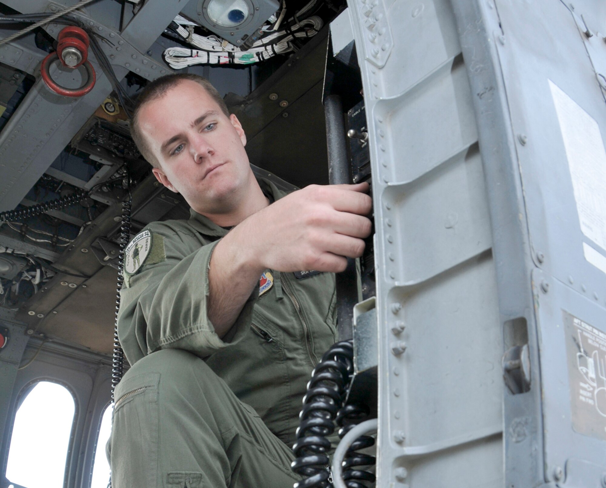 Senior Airman Jacob Ellwood checks all systems as he readies a HH-60G Pave Hawk helicopter for a mission Nov. 6, 2010, at Moffett Federal Airfield, Calif. Airman Ellwood is a flight engineer assigned to the California Air National Guard's 129th Rescue Squadron. (U.S. Air Force photo/Staff Sgt. Kim E. Ramirez)