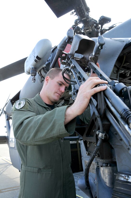 Senior Airman Jacob Ellwood conducts a preflight check on a HH-60G Pave Hawk helicopter Nov. 6, 2010, at Moffett Federal Airfield, Calif. Airman Ellwood is a flight engineer with the California Air National Guard's 129th Rescue Squadron. (U.S. Air Force photo/Staff Sgt. Kim E. Ramirez)