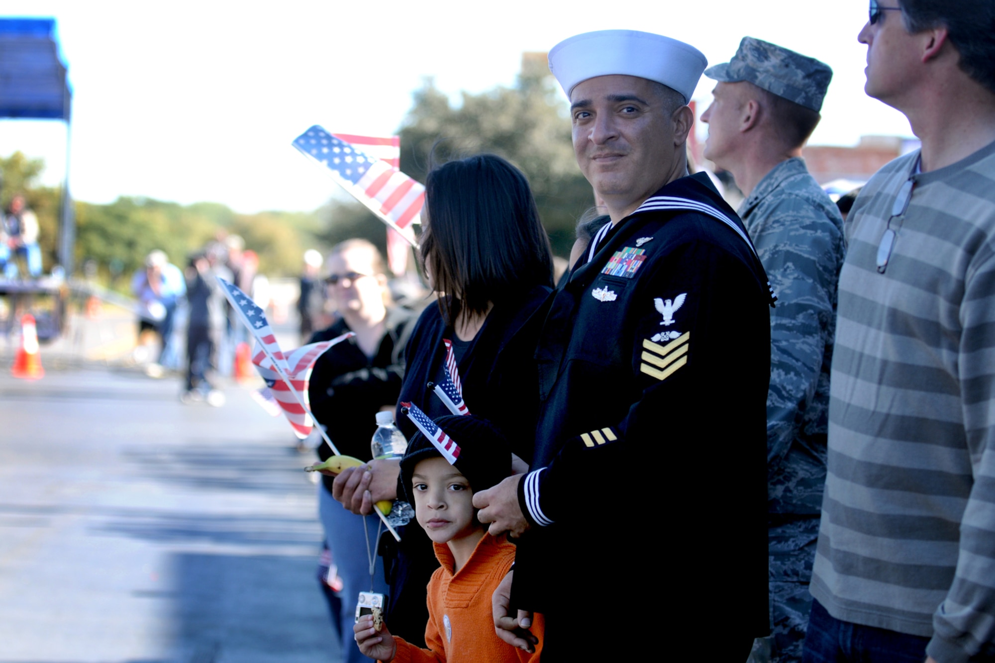 SAN ANGELO, Texas – Petty Officer First Class Gabriel Figueroa, 312th Training Squadron , watches the San Angelo Veteran’s Day Parade with his family Nov. 6.  (U.S. Air Force photo /Staff Sgt. Heather L. Rodgers)