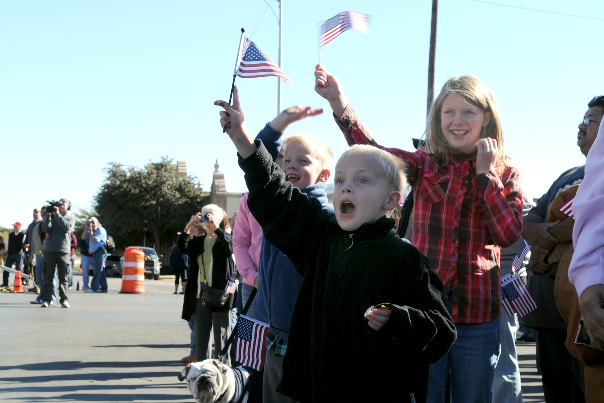 SAN ANGELO, Texas – Ethan Curtis, son of Army Maj. Stuart Curtis, 344 Military Intelligence Battalion Executive Officer, waves to Sparky the Firedog during the San Angelo Veteran’s Day Parade Nov. 6. Ethan and his family came out to see the parade and to honor those who have served the country. (U.S. Air Force photo /Staff Sgt. Heather L. Rodgers)
