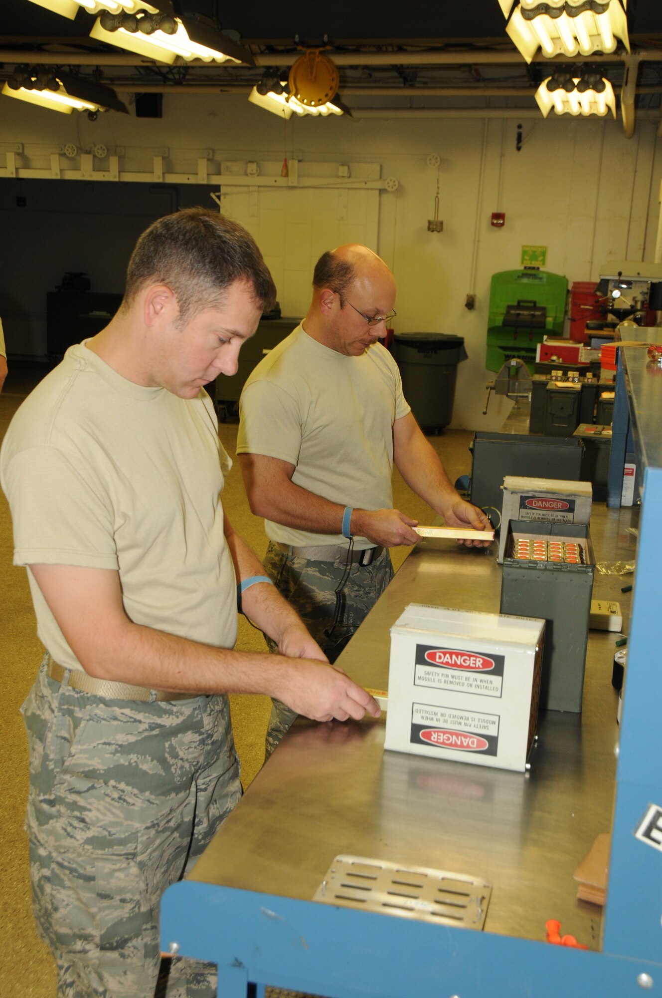 Tech. Sgt. Paul Przybyl (left) and Staff Sgt. Thomas Perreault both from the 107th Airlift Wing load M211 decoys into one of the 18 Modules that will be place on a C-130 for an upcoming exercise. (U.S. Air Force photo/Senior Master Sgt. Ray Lloyd)  