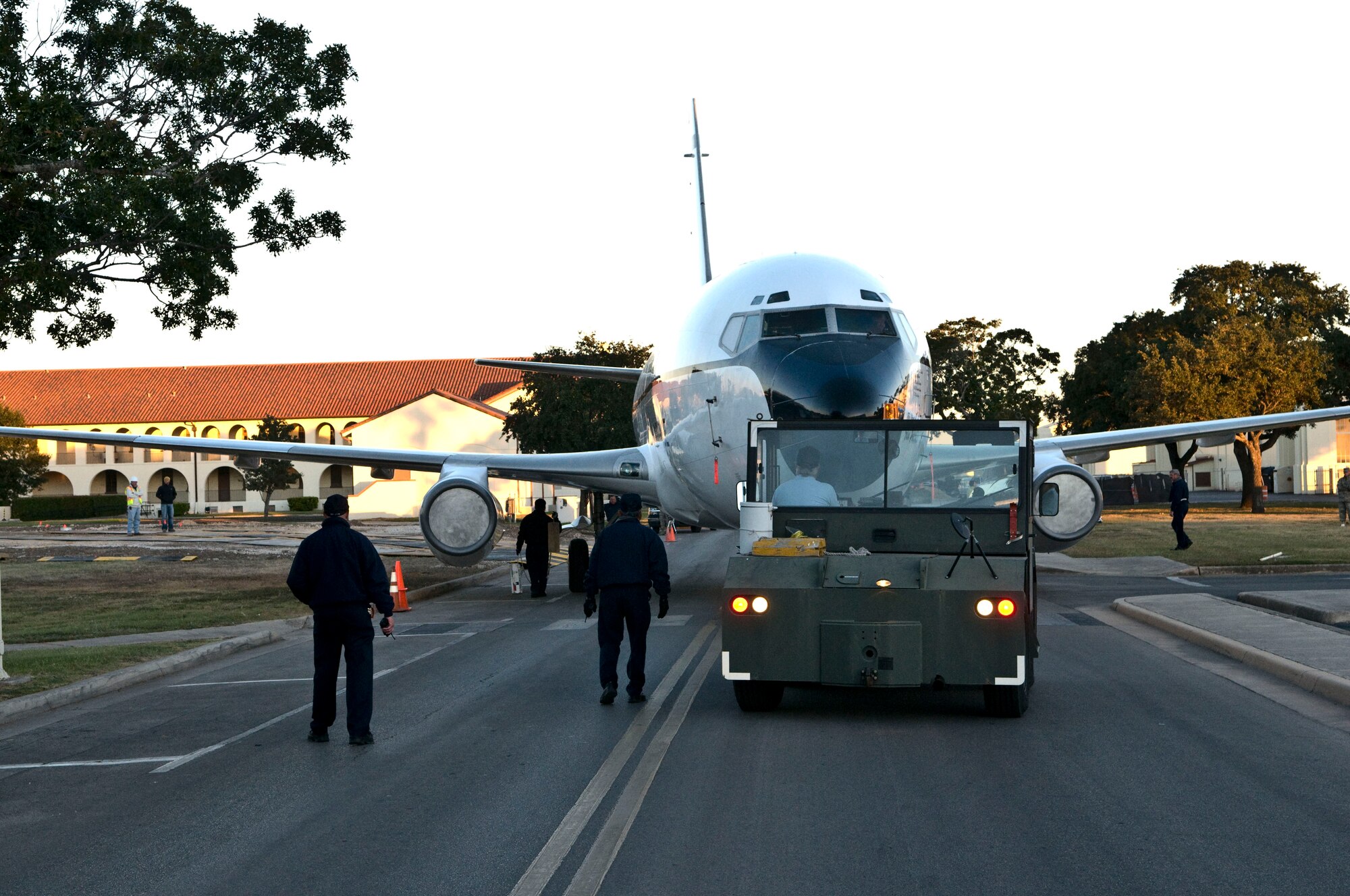 Members of the 12th Flying Training Wing Maintenance Directorate move Randolph’s last remaining T-43A across the street from base operations in preparation for putting the aircraft on static display. The T-43A was used by the 562nd and 563rd Flying Training Squadrons training combat systems officers at Randolph for 17 years. The retired aircraft was moved into position during the early morning hours of Nov. 6.  (U.S. Air Force photo/Don Lindsey)