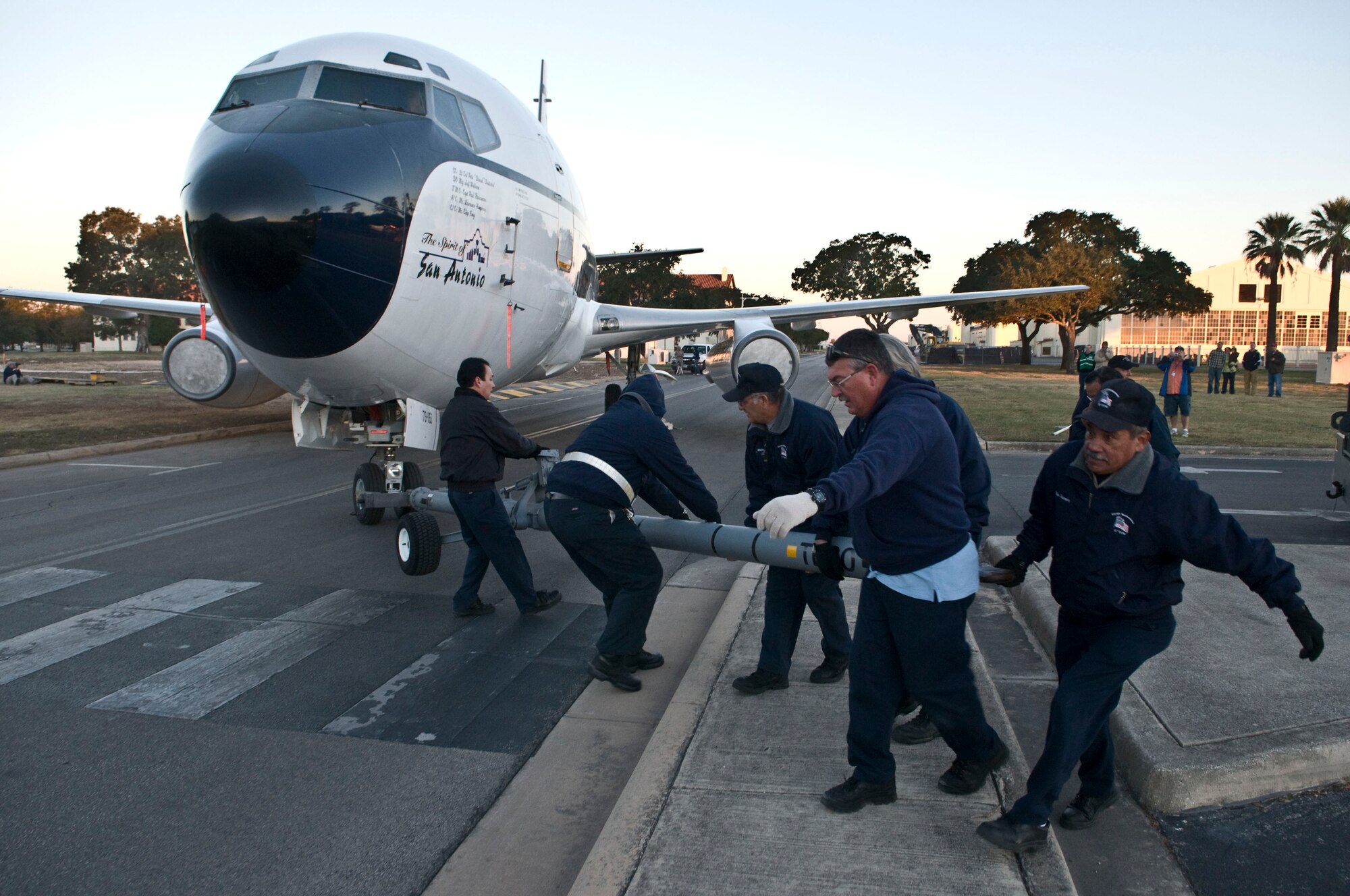 Members of the 12th Flying Training Wing Maintenance Directorate move Randolph’s last remaining T-43A across the street from base operations in preparation for putting the aircraft on static display. The T-43A was used by the 562nd and 563rd Flying Training Squadrons training combat systems officers at Randolph for 17 years. The retired aircraft was moved into position during the early morning hours of Nov. 6.  (U.S. Air Force photo/Don Lindsey)