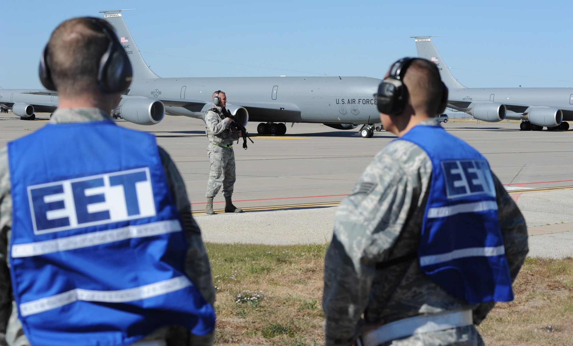 Exercise Evaluation Team members observe as a 22nd Security Forces Squadron Airman guards McConnell’s KC-135 Stratotankers during an exercise Nov. 6, 2010, McConnell Air Force Base, Kan. Ensuring the security of McConnell’s KC-135 fleet is a priority for the 22nd SFS. McConnell’s has the world’s largest KC-135 fleet that supports humanitarian and contingency operation globally.  (U.S. Air Force photo/Airman 1st Class Armando A. Schwier-Morales)