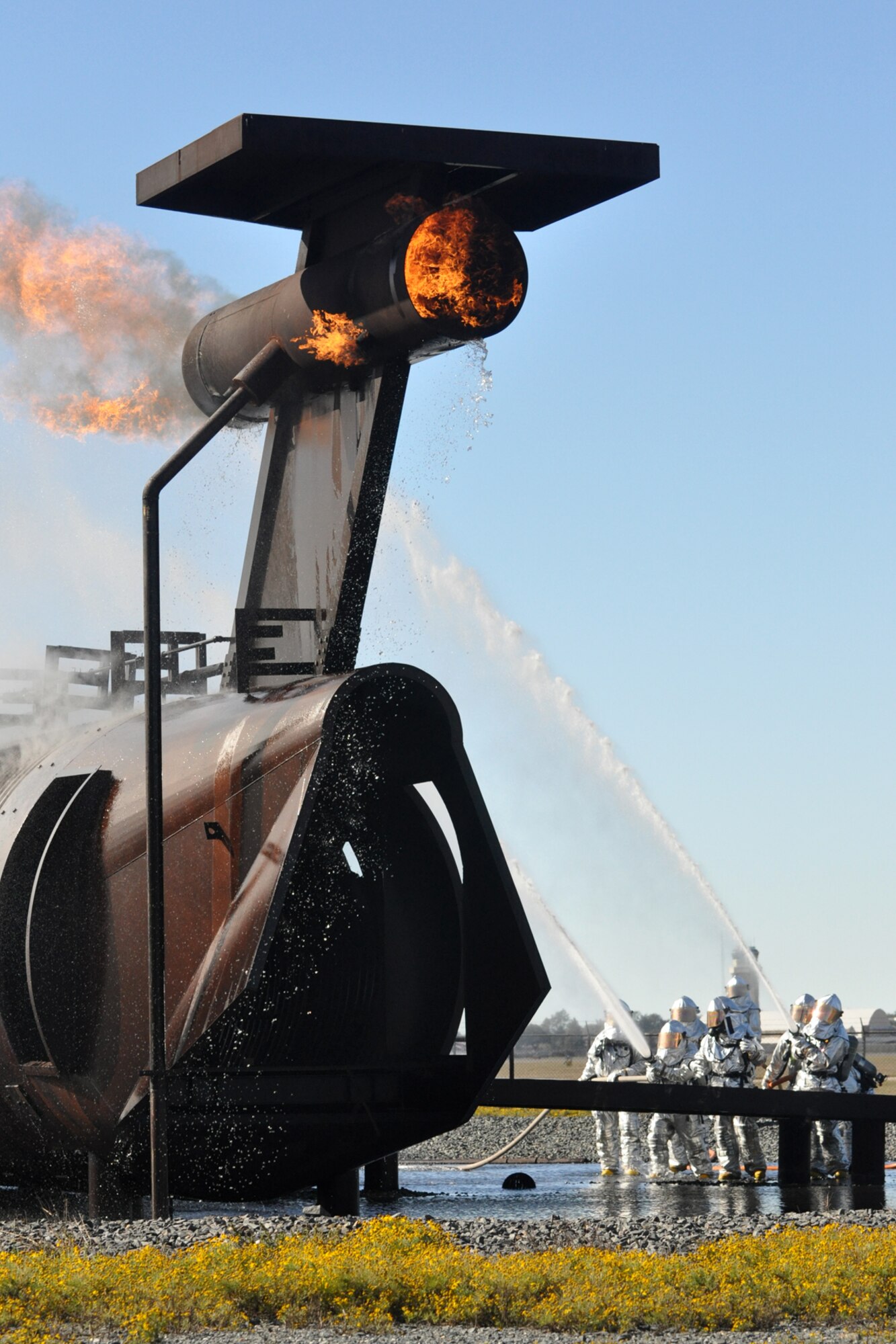 Firefighters with the 917th Civil Engineer Squadron put out the final flames on a large frame aircraft trainer during annual wartime training at Barksdale Air Force Base, La., Nov. 5, 2010. Approximately 20 members of the 917 CES were involved in this phase, which included extinguishing a fire on both the outside and inside of the trainer. It was a part of their annual Air Force Certification process for Airport Rescue Firefighting.  (U.S. Air Force photo/Tech. Sgt. Jeff Walston) 