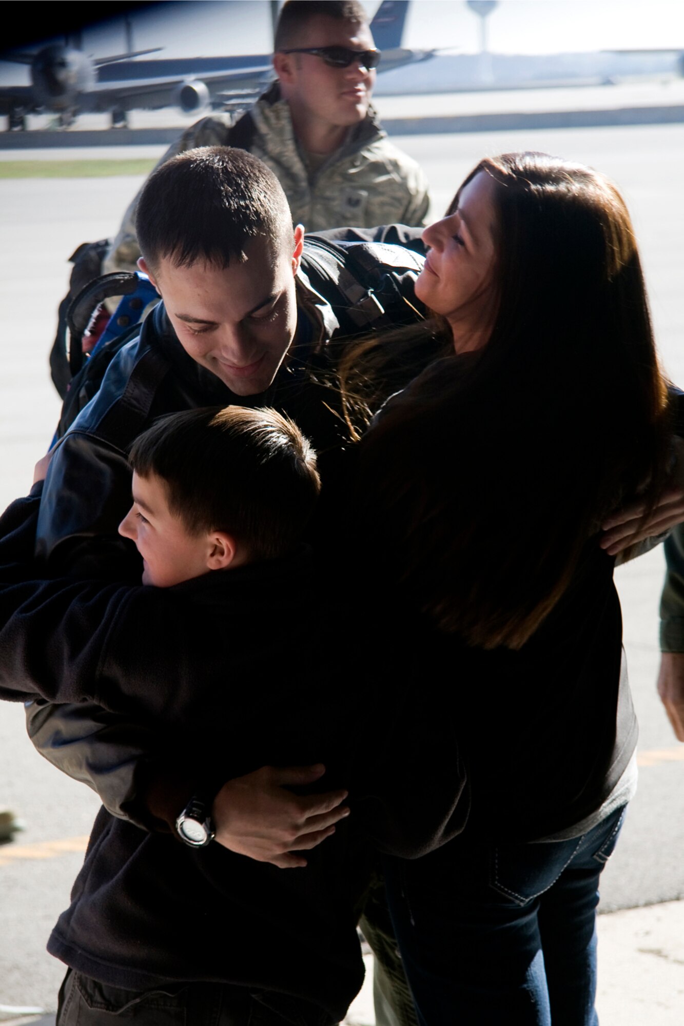 GRISSOM AIR RESERVE BASE, Ind. -- Welcomed home with open arms, 1st Lt. Daniel Kartchner, a 72nd Air Refueling Squadron pilot, hugs his wife Kacy and son Aiden, 8, after returning from a recent deployment Nov. 2. (U. S. Air Force photo/Tech. Sgt. Mark R. W. Orders-Woempner)
