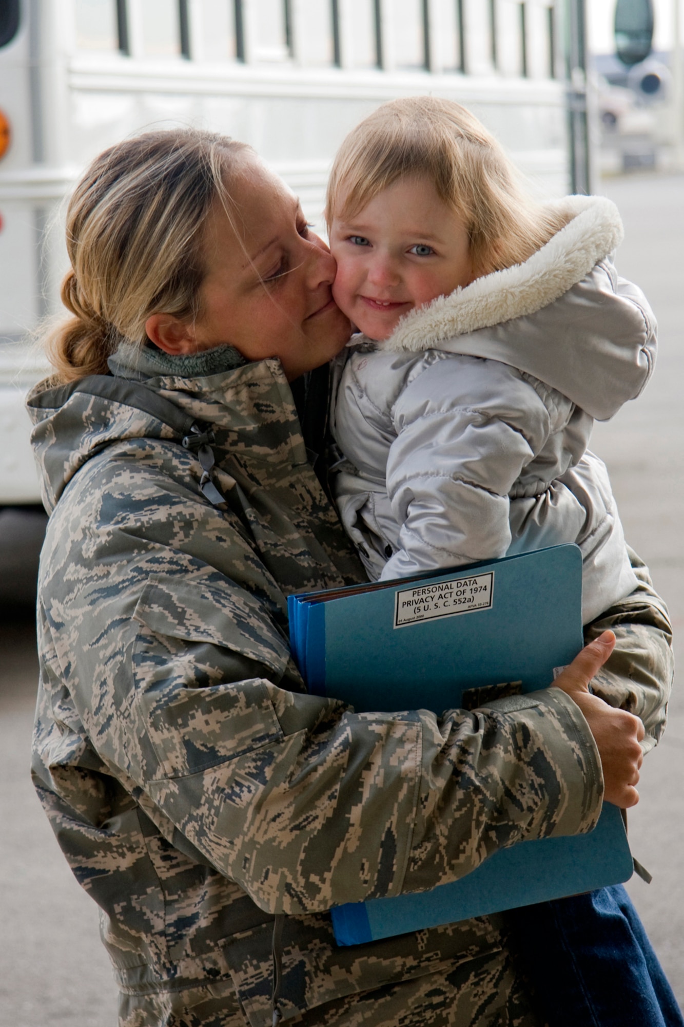 GRISSOM AIR RESERVE BASE, Ind. -- Tech. Sgt. Lindsay Stoll embraces her 3 year old daughter Alexa right after landing here Nov. 3 following a recent deployment. Sergeant Stoll, a radio communication systems journeyman with the 434th Operations Support Squadron, returned with other Grissom Airmen from deployments around the world. (U. S. Air Force photo/Tech. Sgt. Mark R. W. Orders-Woempner)