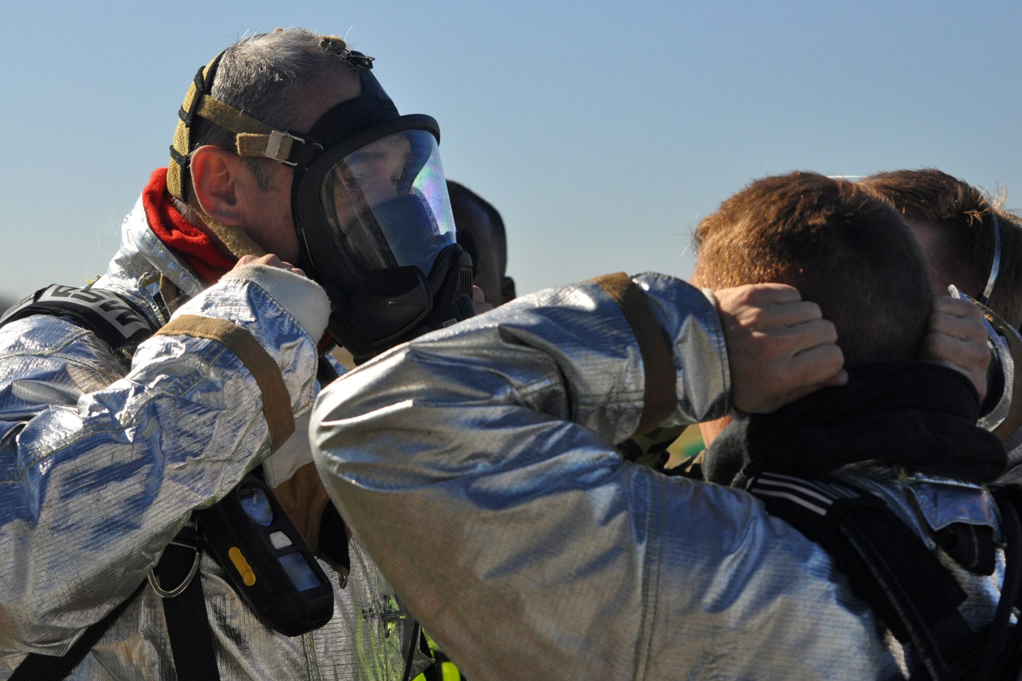 Col. John J. Mooney III, commander, 917th Wing, dons a mask in preparation for learning to extinguish a fuel fire on board a jet aircraft at Barksdale Air Force Base, La., Nov. 5, 2010. Colonel Mooney decided to take up the challenge, in order to experience and get a feel for what Airmen in his command go through on a daily basis. He joined approximately 20 members of the 917 CES in this phase of wartime training, which included the extinguishing of a fire on a large frame aircraft trainer. The training was a part of the firefighter’s annual Air Force Certification process for Airport Rescue Firefighting.  (U.S. Air Force photo/Tech. Sgt. Jeff Walston) 