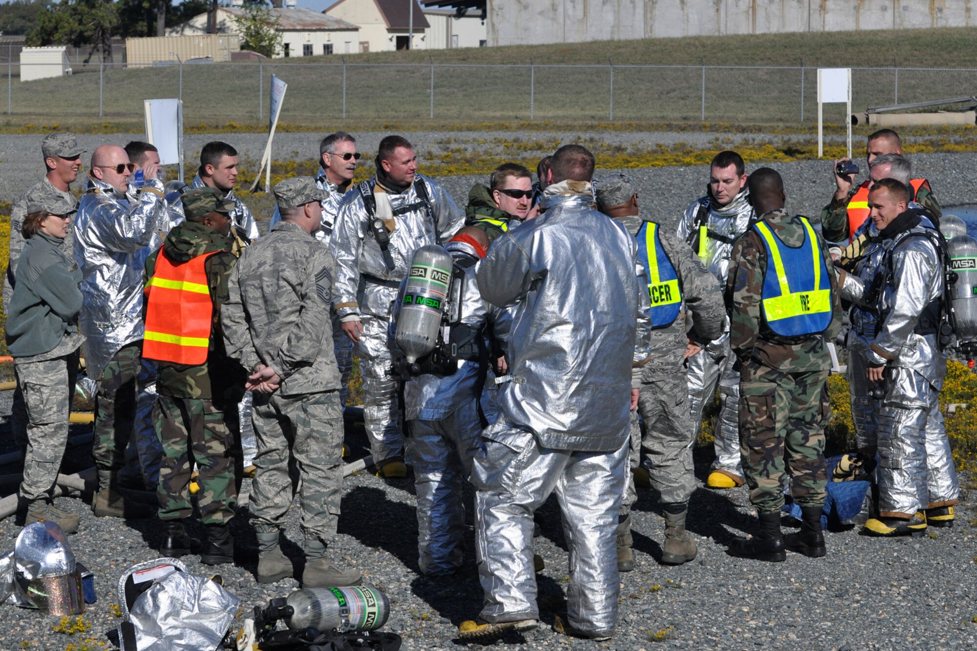 Members of the 917th Civil Engineer Squadron gather for a critique of their professional skills by Master Sgt. Charles Mitchell, a firefighter for the 917 CES, and incident commander during the annual wartime training at Barksdale Air Force Base, La., Nov. 5, 2010. Approximately 20 members of the 917 CES were involved in this phase, which included extinguishing fires on a large frame aircraft trainer. It was a part of their annual Air Force Certification process for Airport Rescue Firefighting.  (U.S. Air Force photo/Tech. Sgt. Jeff Walston) 