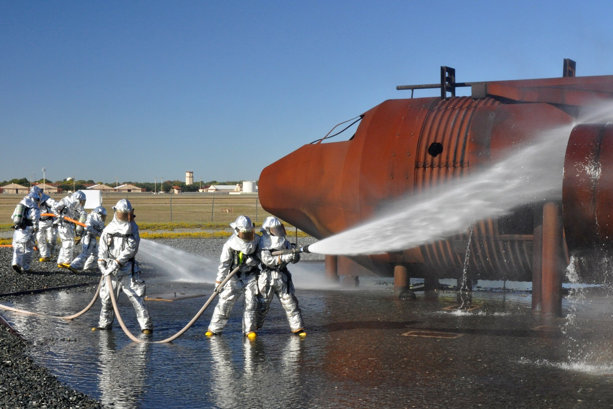 Firefighters with the 917th Civil Engineer Squadron extinguish a fire on the outside of a large frame aircraft trainer during annual wartime training on Barksdale Air Force Base, La., Nov. 5, 2010. Approximately 20 members of the 917 CES were involved in this phase, which included extinguishing fires on both the outside and inside of the aircraft trainer. It was a part of their annual Air Force Certification process for Airport Rescue Firefighting.  (U.S. Air Force photo/Tech. Sgt. Jeff Walston) 

