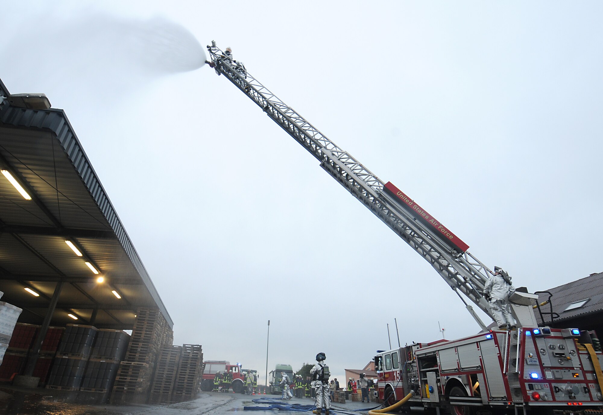 BINSFELD, Germany – Firefighters from the 52nd Civil Engineer Squadron spray water over a simulated fire at a plastic factory Nov. 6.  This was part of a joint exercise with German firefighters and first responders from eight nearby departments in which the German firefighters treated injuries, and the Spangdahlem Airmen helped extinguish the fire.  (U.S. Air Force photo/Staff Sgt. Logan Tuttle)