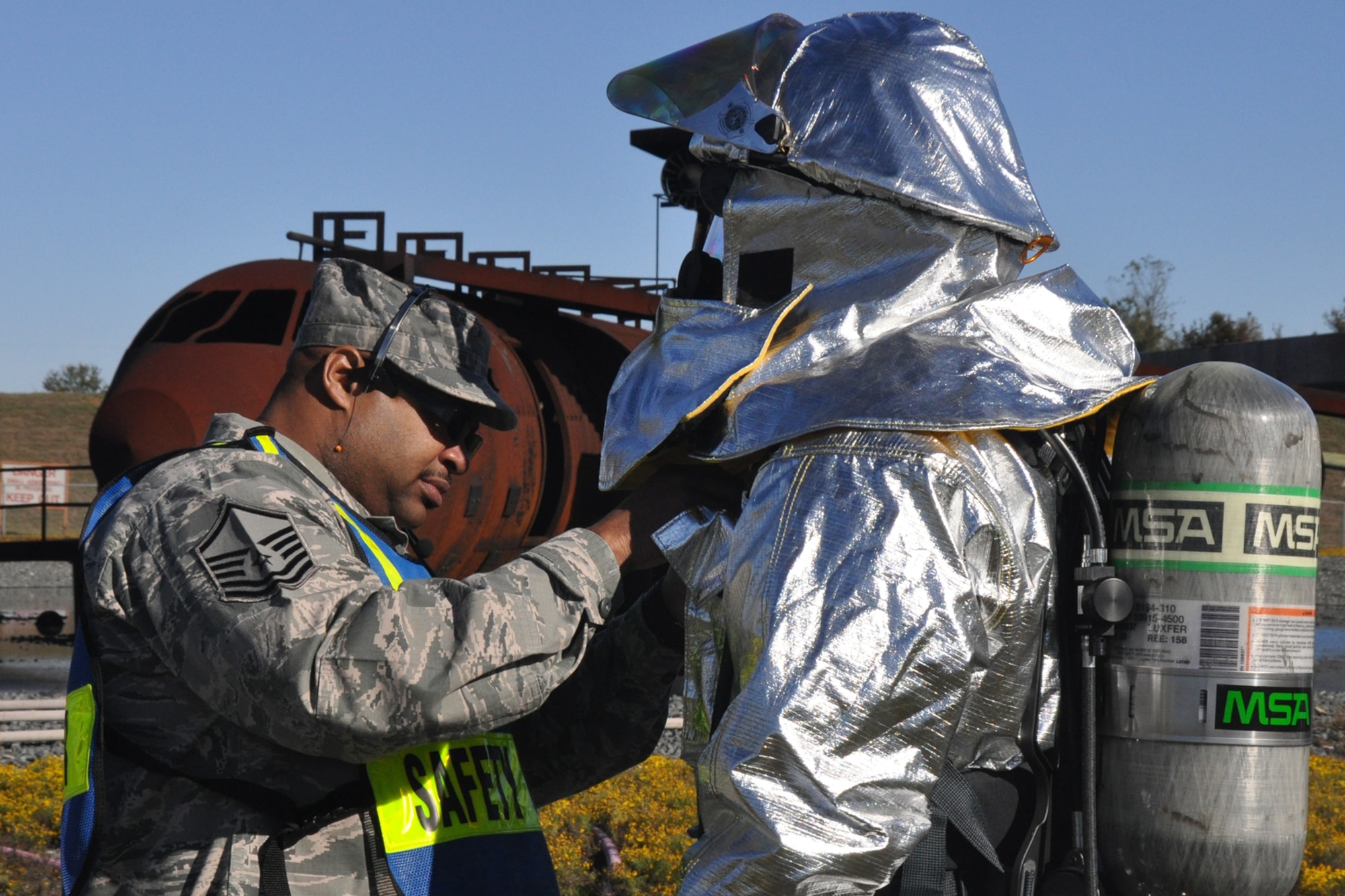 Master Sgt. Demetrius Wallace, a safety officer for a 917th Civil Engineer Squadron, checks the equipment of one of his fellow Airmen before letting him participate in an annual wartime training exercise at Barksdale Air Force Base, La., Nov. 5, 2010. Approximately 20 members of the 917 CES were involved in this phase, which included extinguishing fires on a large frame aircraft trainer. It was a part of their annual Air Force Certification process for Airport Rescue Firefighting.  (U.S. Air Force photo/Tech. Sgt. Jeff Walston) 