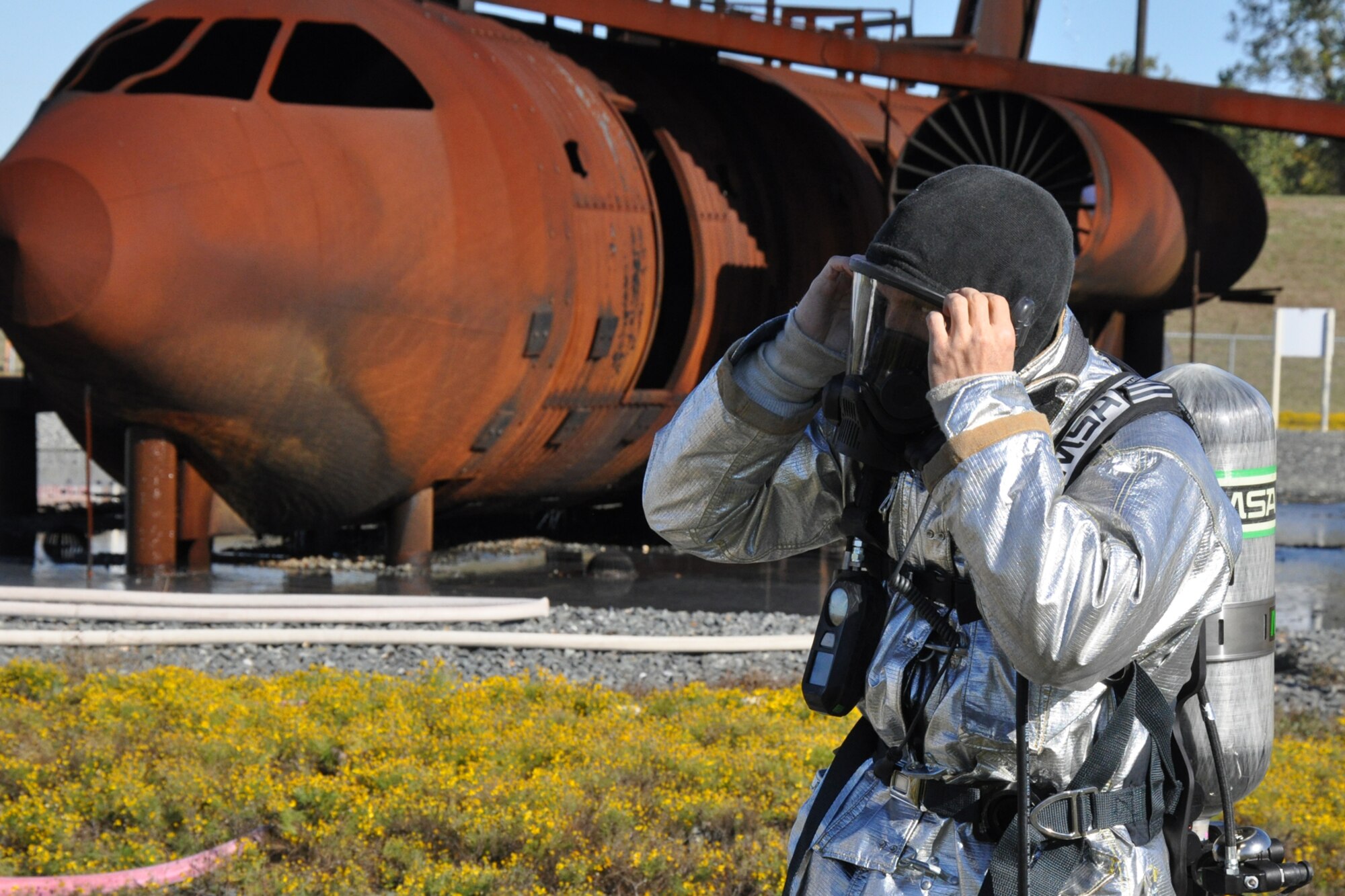Staff Sgt. Jerry Bays, a firefighter with the 917th Civil Engineer Squadron suits up before beginning annual wartime training at Barksdale Air Force Base, La., Nov. 5, 2010. Approximately 20 members of the 917 CES were involved in this phase, which included extinguishing fires on both the outside and inside of a large frame aircraft trainer. It was a part of their annual Air Force Certification process for Airport Rescue Firefighting.  (U.S. Air Force photo/Tech. Sgt. Jeff Walston) 