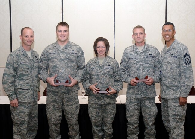 Col. James Clavenna, left, and Chief Master Sgt. Terrence Greene, right, are joined by three of November's "Diamond Sharp" recipients Nov. 2, 2010, at the Charleston Club on Joint Base Charleston-Air Base, S.C. The award winners present were, from left, Senior Airman Kent Boatright from the 437th Maintenance Squadron, Senior Airman Jessica Dial from the 437th Aircraft Maintenance Squadron and Staff Sgt. Robert Pennington from the 437th Maintenance Operations Squadron. A fourth winner, Senior Airman Kyle Mace from the 14th Airlift Squadron, was unable to attend the award ceremony. The Diamond Sharp award is given based on outstanding performance, image, volunteerism, as well as significant self, peer, and community improvement. Each recipient is chosen for the award by their unit first sergeant. Colonel Clavenna is the 437th Maintenance Group commander, and Chief Greene is the 437th Airlift Wing command chief. (U.S. Air Force photo/Staff Sgt. Marie Brown)