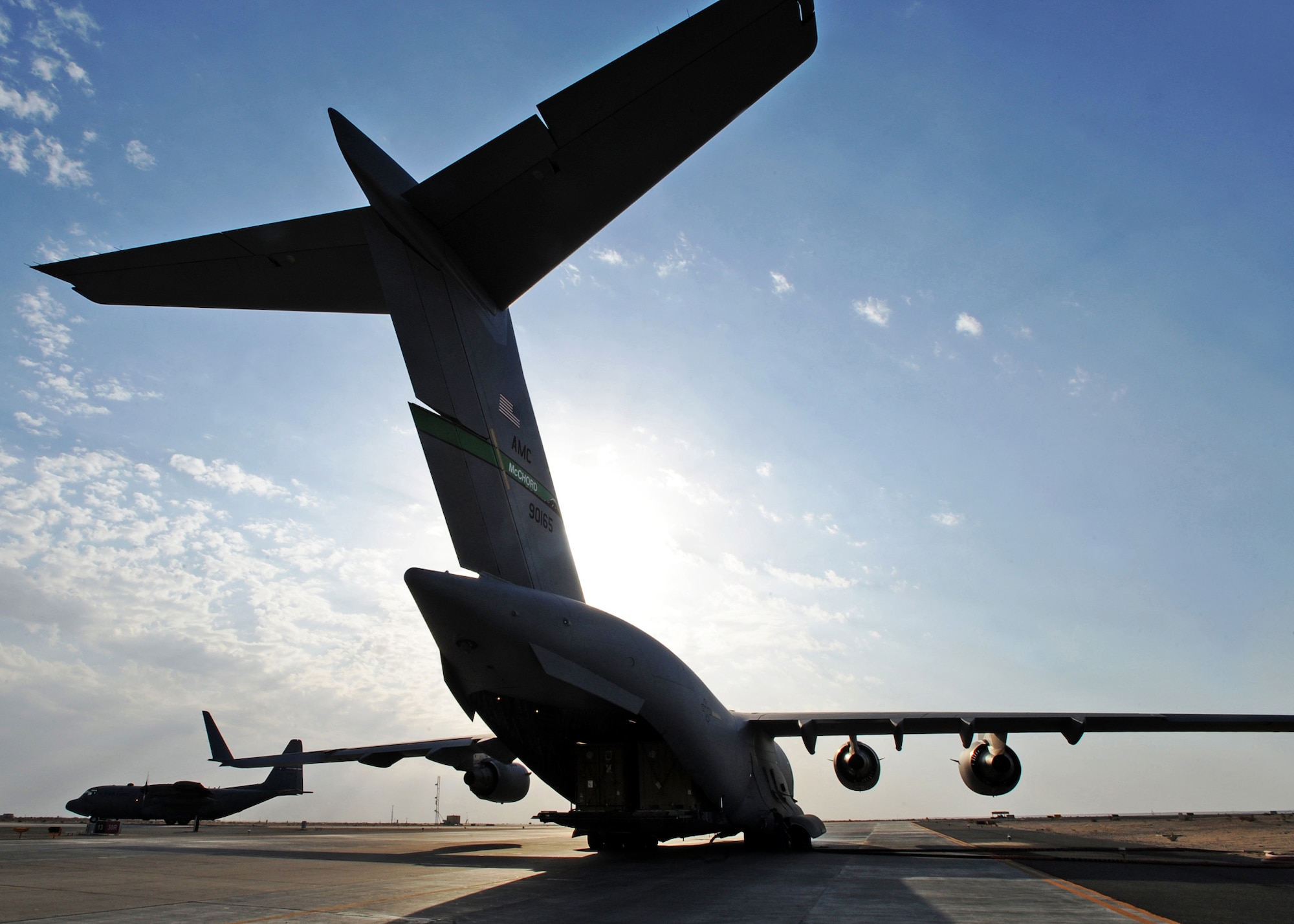 SOUTHWEST ASIA - A C-17 closes its doors at an undisclosed base here Nov. 3, 2010, after being loaded with pallets of cargo by Airmen from the 386th Expeditionary Logistics Readiness Squadron Aerial Port. Known informally as "Port Dogs," Aerial port Airmen inspect and palletize all cargo before shipment, from food and water to ammunition and rolling stock. They also work closely with aircraft loadmasters to carefully position the cargo inside aircraft, loading it into planes with massive forklifts or special flat-bed trucks known as K-loaders. (U.S. Air Force photo by Senior Airman Laura Turner)
