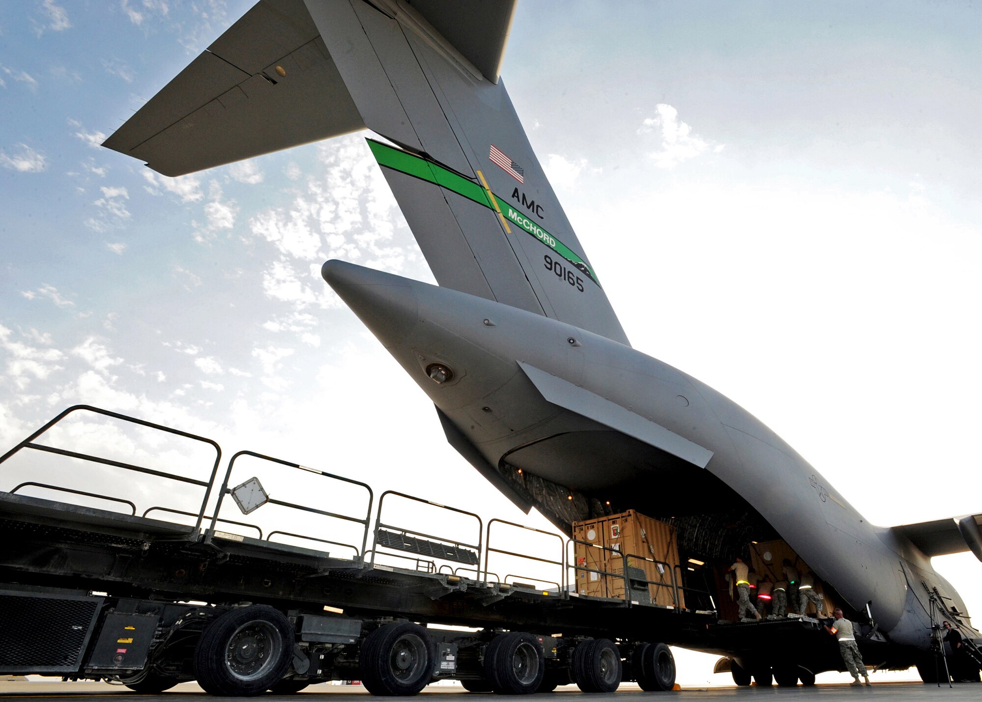 SOUTHWEST ASIA - Airmen from the 386th Expeditionary Logistics Readiness Squadron Aerial Port use a K-loader to load pallets of cargo onto a C-17 Globemaster III at an undisclosed air base here Nov. 3, 2010. A K-loader is a specialized flat-bed truck designed to carry multiple pallets of cargo from a marshalling yard to waiting aircraft. The K-loader's bed can be raised, lowered or pitched in four different directions so that it mates perfectly with the cargo bay of any airlifter. The bed also is fitted with a roller system that allows Airmen to push pallets weighing up to 7,000 pounds off the truck and onto aircraft with ease. (U.S. Air Force photo by Senior Airman Laura Turner)