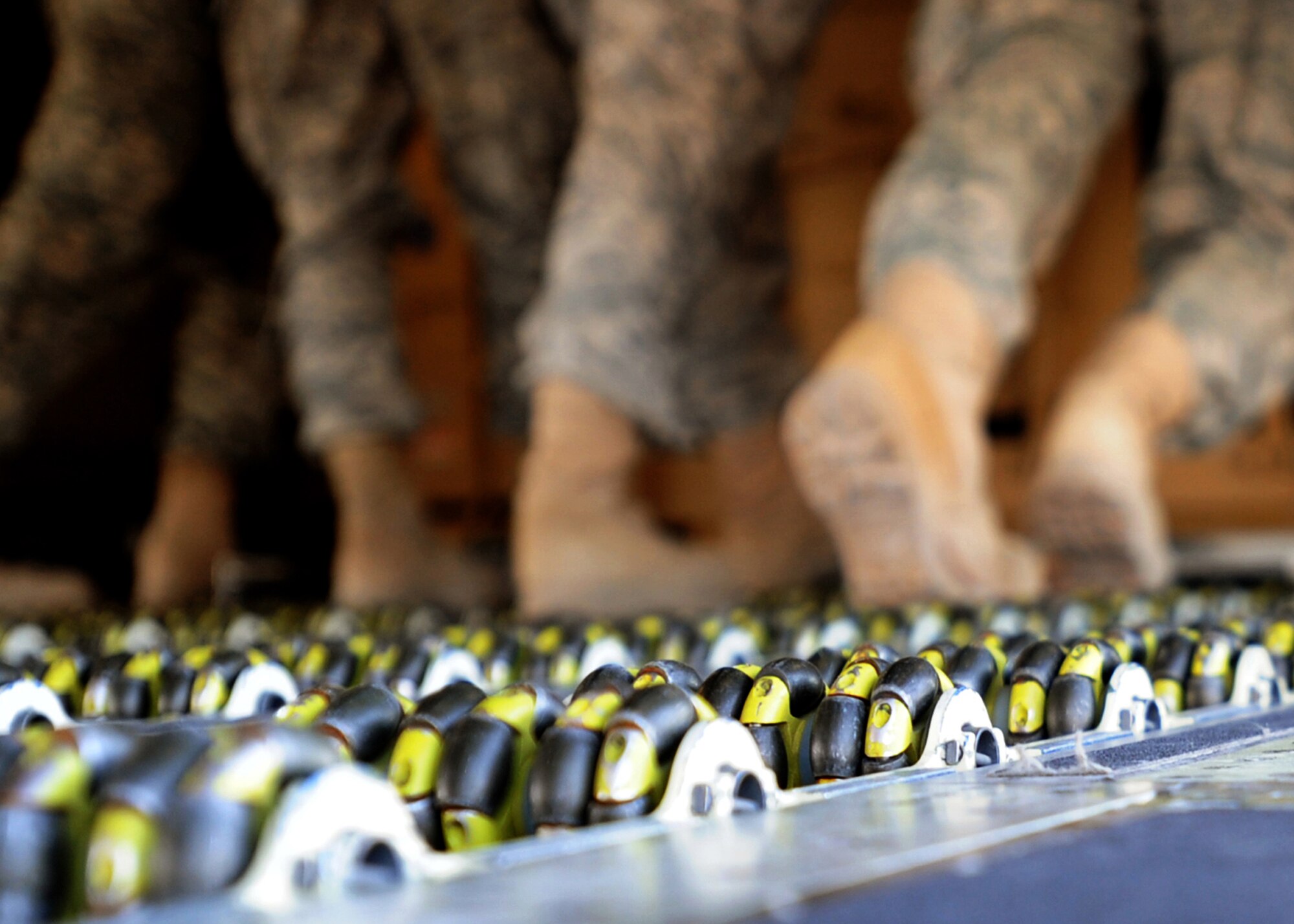 SOUTHWEST ASIA -- A system of rollers in the floor of C-17 Globemaster III aircraft help Airmen push palletized cargo onto the plane at an undisclosed air base here Nov. 3, 2010. Known informally as "Port Dogs," Aerial port Airmen inspect and palletize all cargo before shipment, from food and water to ammunition and rolling stock. They also work closely with aircraft loadmasters to carefully position the cargo inside aircraft, loading it into planes with massive forklifts or special flat-bed trucks known as K-loaders. (U.S. Air Force photo by Senior Airman Laura Turner)