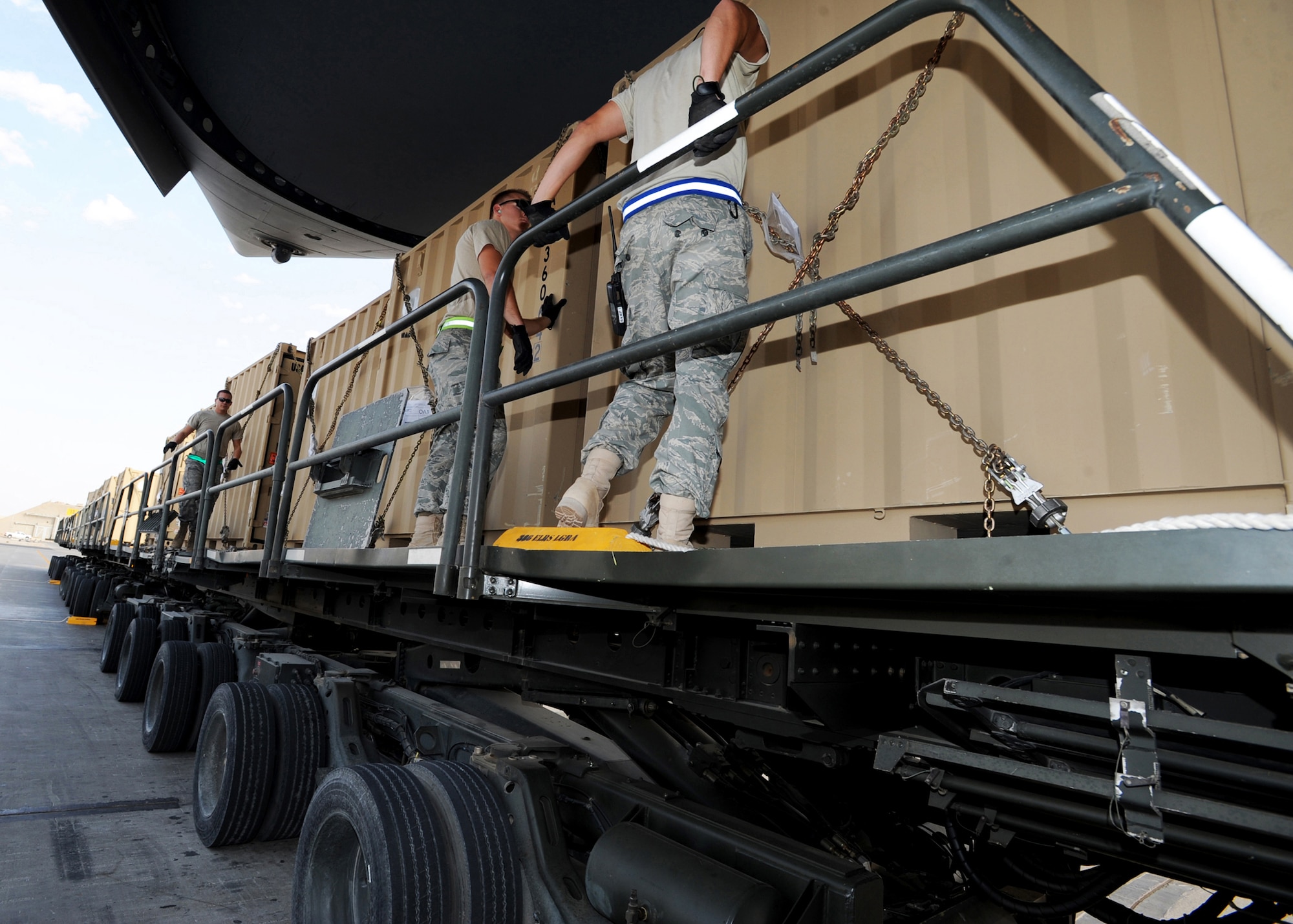 SOUTHWEST ASIA - Airmen from the 386th Expeditionary Logistics Readiness Squadron Aerial Port prepare to push pallets of cargo from a K-loader onto a waiting C-17 Globemaster III at an undisclosed air base here Nov. 3, 2010. A K-loader is a specialized flat-bed truck designed to transport multiple pallets of cargo from a marshalling yard to waiting aircraft. The K-loader's bed can be raised, lowered or pitched in four different directions so that it mates perfectly with the cargo bay of any airlifter. The bed also is fitted with a roller system that allows Aerial Port Airmen to push pallets weighing up to 7,000 pounds off the truck and onto aircraft with ease. (U.S. Air Force photo by Senior Airman Laura Turner)