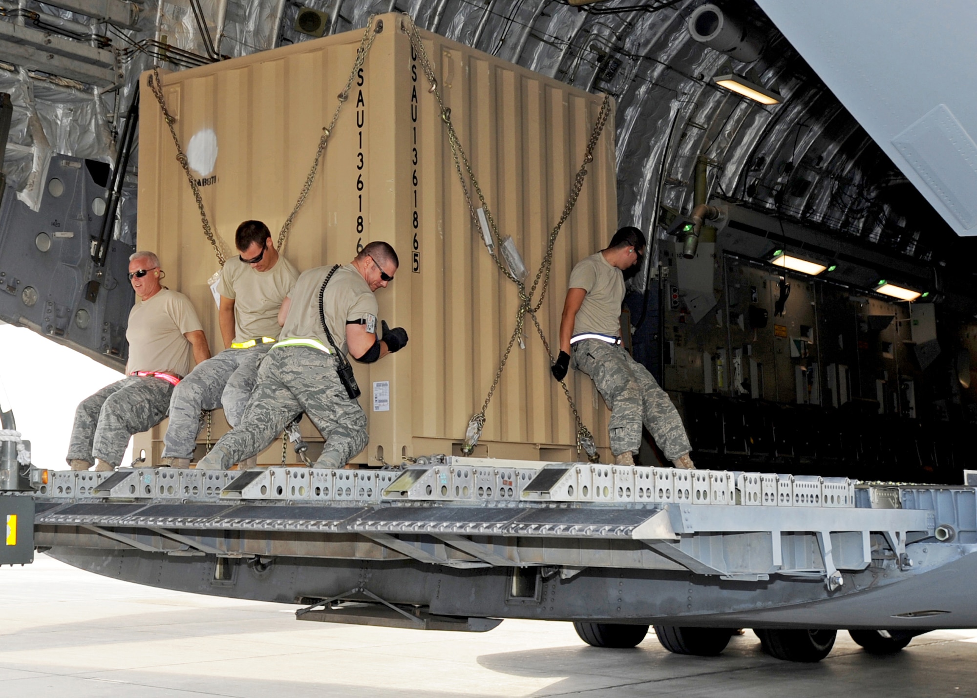 SOUTHWEST ASIA - Airmen from the 386th Expeditionary Logistics Readiness Squadron Aerial Port move a pallet of cargo onto a C-17 Globemaster III at an undisclosed air base here Nov. 3, 2010. Known informally as "Port Dogs," Aerial port Airmen inspect and palletize all cargo before shipment, from food and water to ammunition and rolling stock. They also work closely with aircraft loadmasters to carefully position the cargo inside aircraft, loading it into planes with massive forklifts or special flat-bed trucks known as K-loaders. (U.S. Air Force photo by Senior Airman Laura Turner)