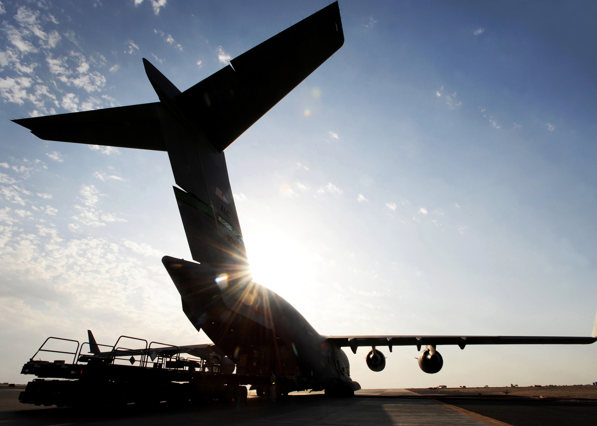 SOUTHWEST ASIA - Airmen from the 386th Expeditionary Logistics Readiness Squadron Aerial Port load pallets of cargo onto a C-17 Globemaster III at an undisclosed air base here Nov. 3, 2010. Known informally as "Port Dogs," Aerial port Airmen inspect and palletize all cargo before shipment, from food and water to ammunition and rolling stock. They also work closely with aircraft loadmasters to carefully position the cargo inside aircraft, loading it into planes with massive forklifts or special flat-bed trucks known as K-loaders. (U.S. Air Force photo by Senior Airman Laura Turner)