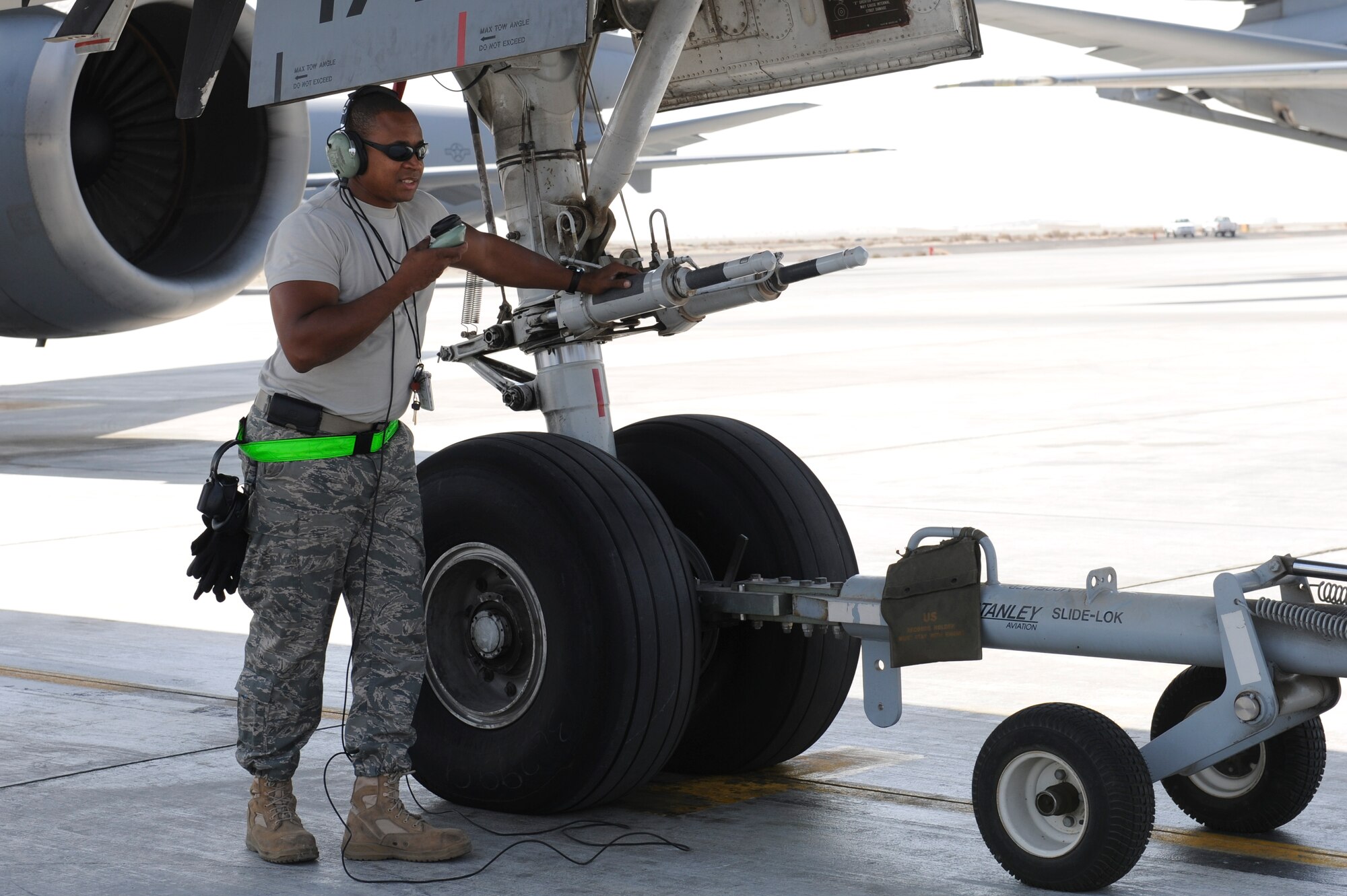 Staff Sgt. Maurice Greenleaf, 380th Expeditionary Aircraft Maintenance Squadron KC-10 Extender crew chief, communicates with the flight deck during aircraft tow-preparation procedures Nov. 5, 2010 at an undisclosed location in Southwest Asia. (U.S. Air Force photo/Tech. Sgt. April Wickes) 