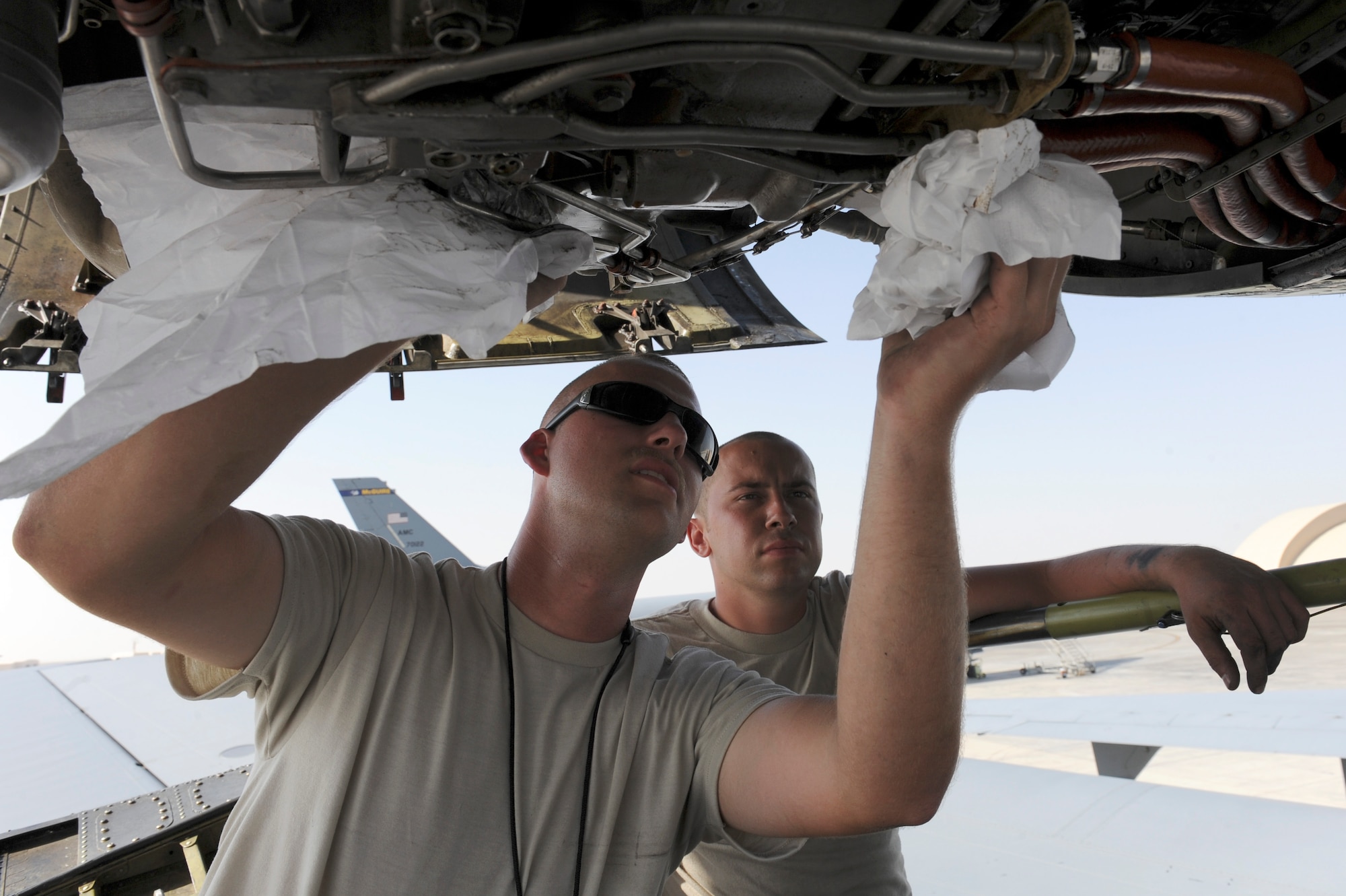 Staff Sgt. Charles Rosemeyer, 380th Expeditionary Aircraft Maintenance Squadron KC-10 Extender Propulsion technician, and Airman 1st Class Alan Kleinart, 380th EAMXS KC-10 electrical/environmental technician, perform a maintenance inspection on the KC-10 number two engine Nov. 5, 2010 at an undisclosed location in Southwest Asia. (U.S. Air Force photo/Tech. Sgt. April Wickes) 