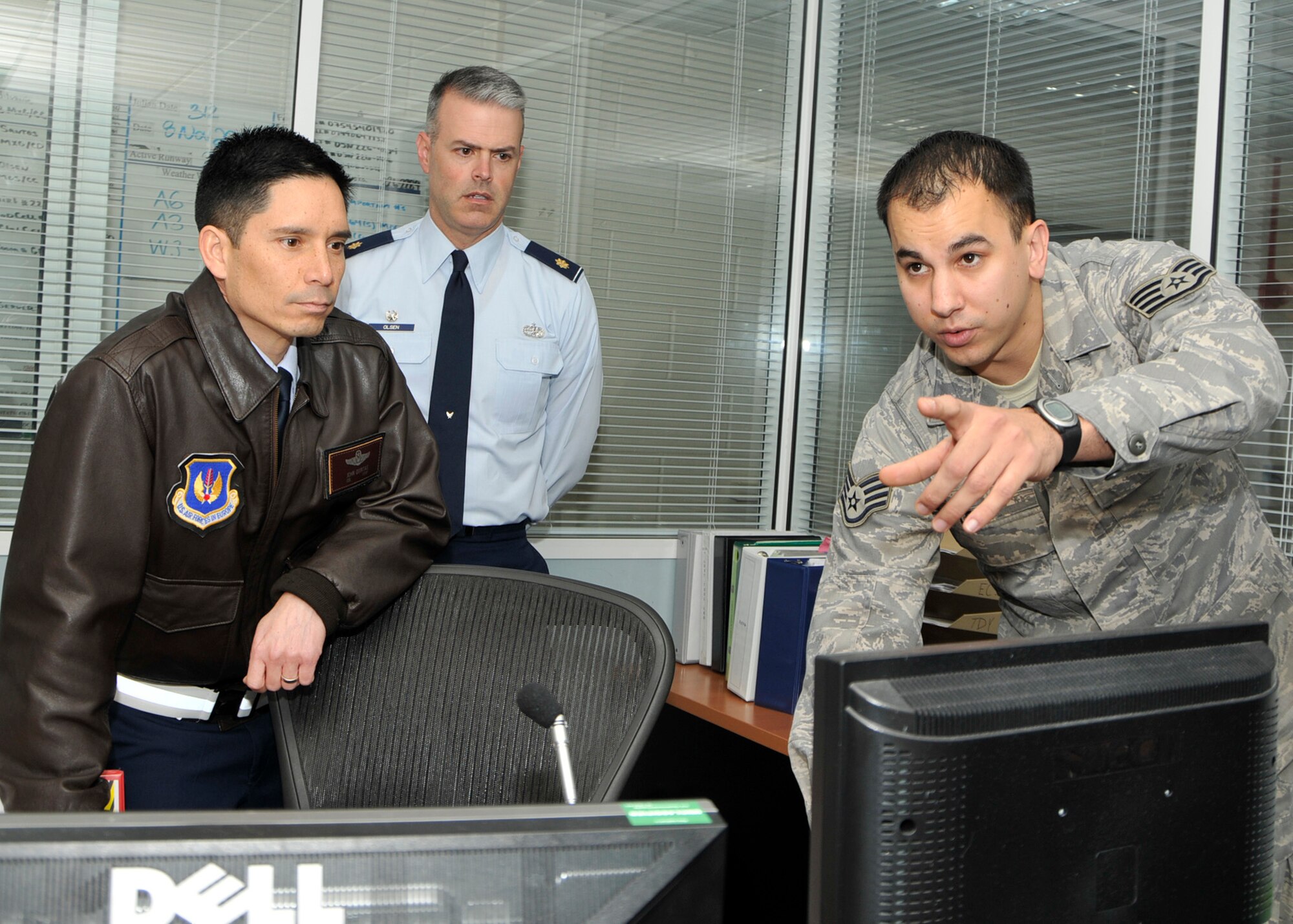 ROYAL AIR FORCE LAKENHEATH, England – 48th Fighter Wing Commander Col. John Quintas listens and Maj. Carl Olsen, 48th Maintenance Operations Squadron commander watches, as Staff Sgt. Alan Leiby, 48th MOS Maintenance Operations Center senior controller provides information during Colonel Quintas’ visit to the MOC on Nov. 8. (U.S. Air Force photo/Airman 1st Class Tiffany M. Deuel)